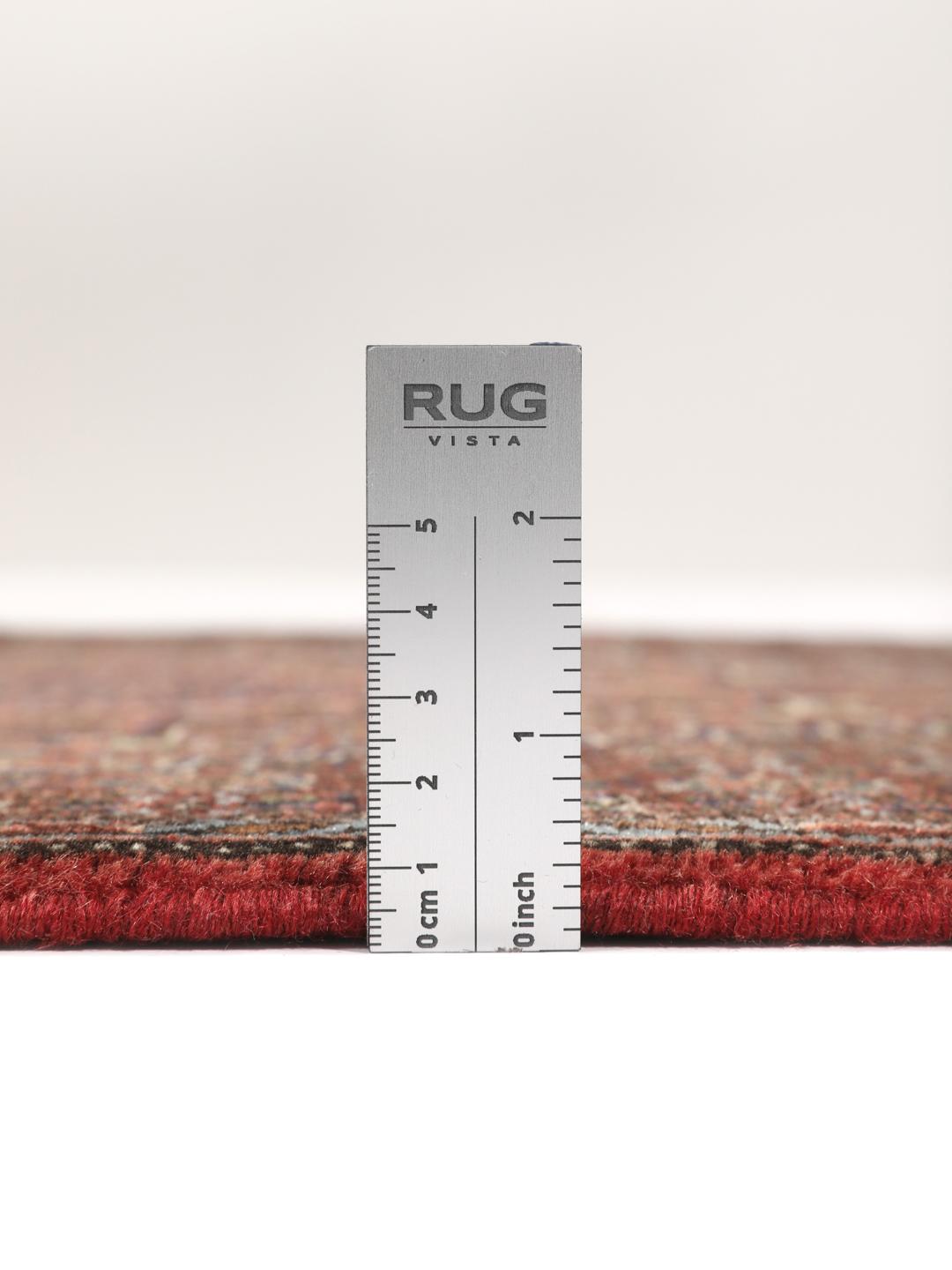 A hand-knotted Senneh rug from the Middle East in dark-red and dark-blue tones.
