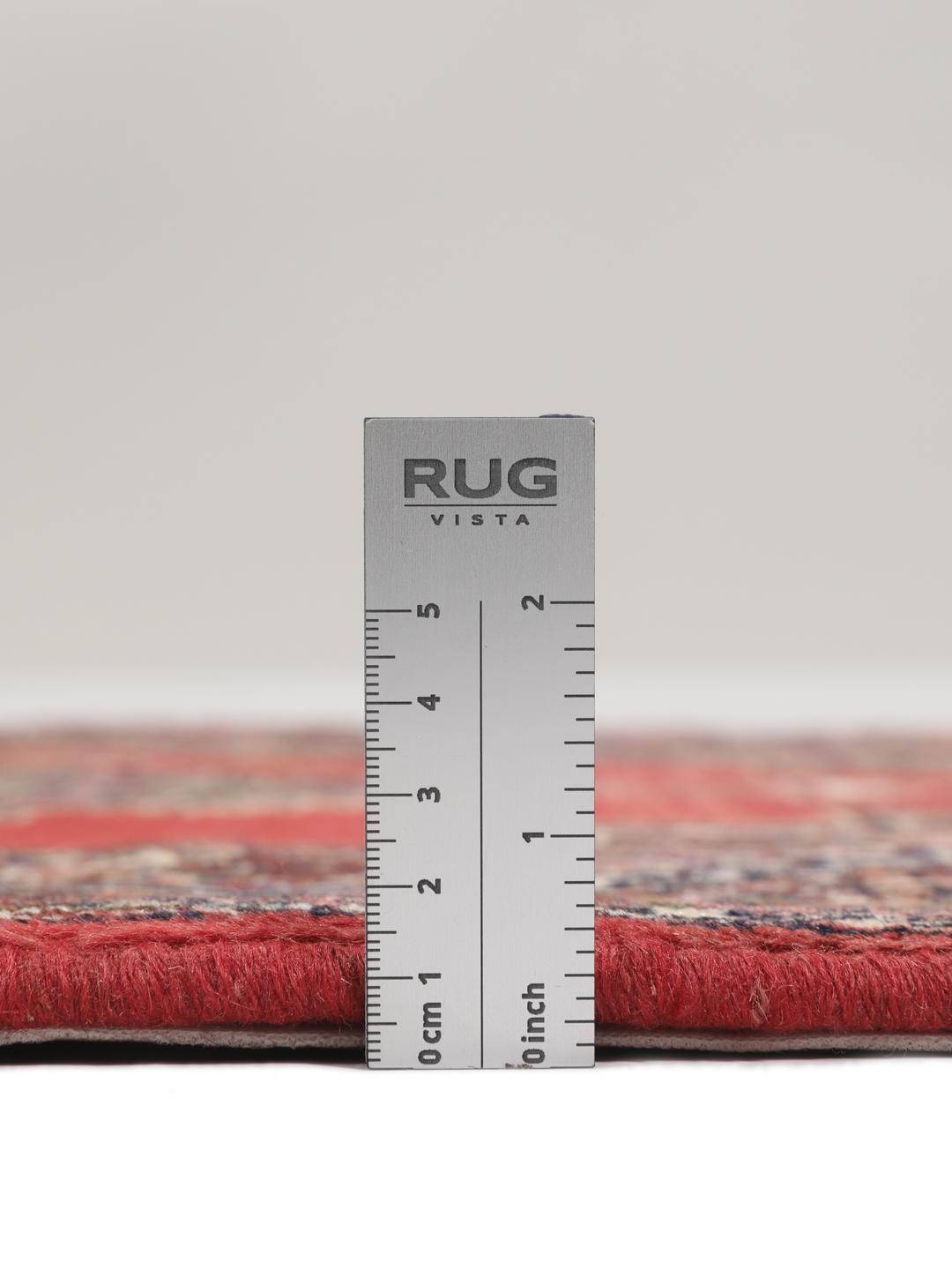 A hand-knotted Senneh rug from the Middle East in red with geometric motifs.
