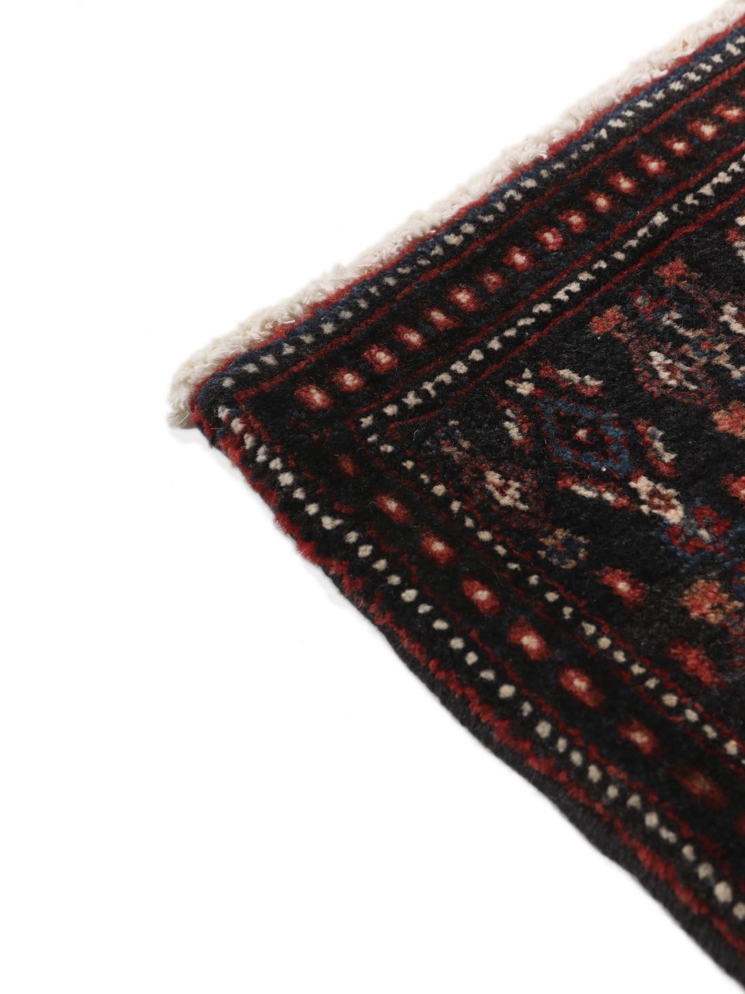 Hand-knotted Senneh rug from the Middle East in dark-blue and dark-red tones.