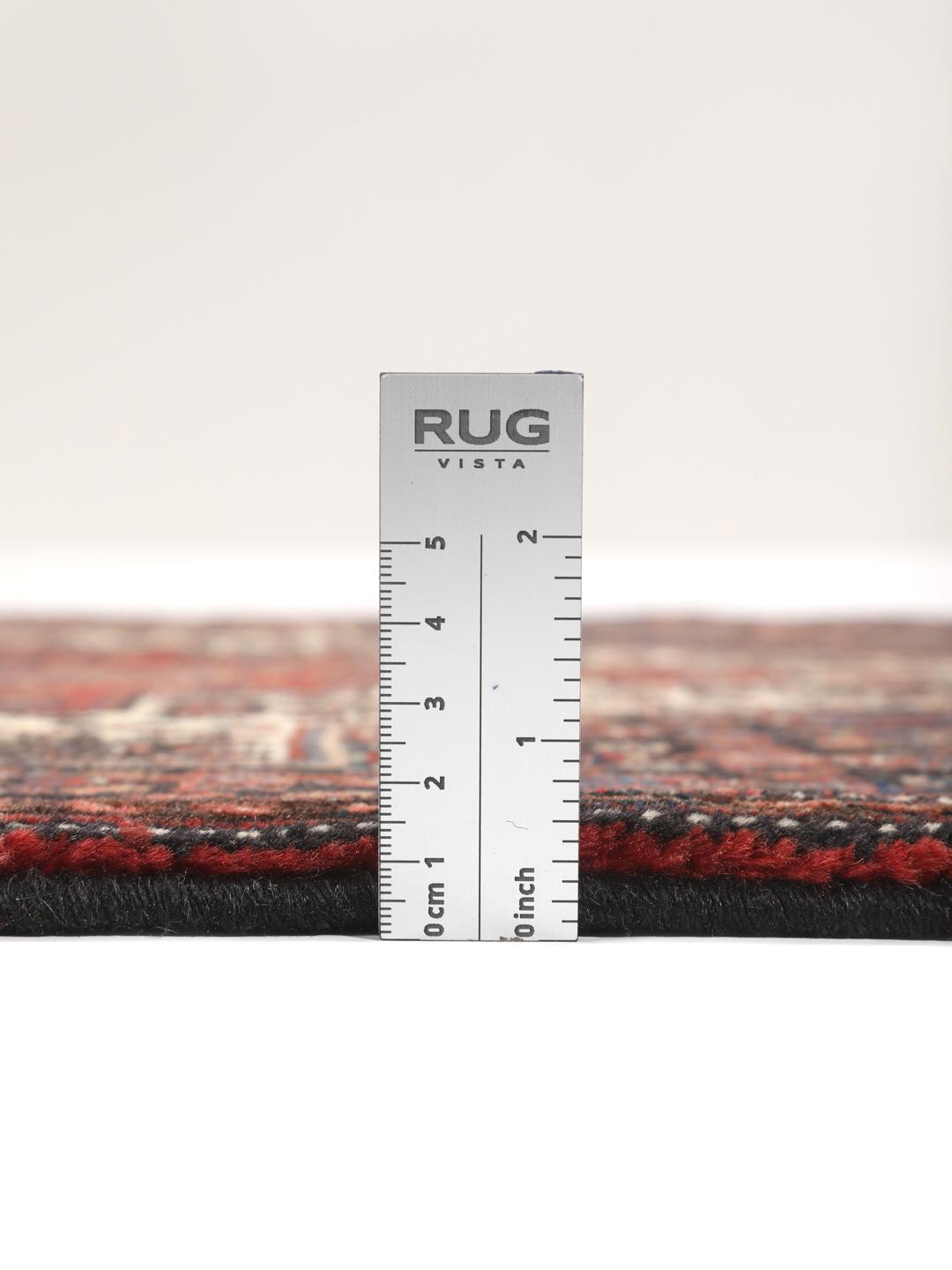 Hand-knotted Senneh rug from the Middle East in dark-blue and dark-red tones.