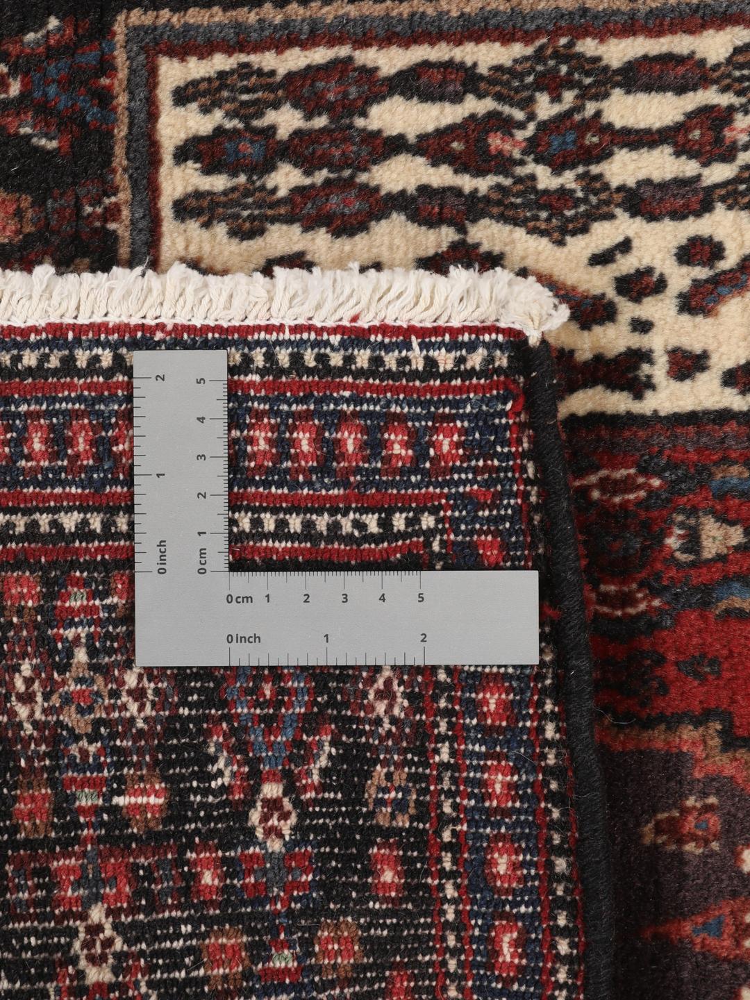 Hand-knotted Senneh rug from the Middle East in dark-blue and dark-red tones.