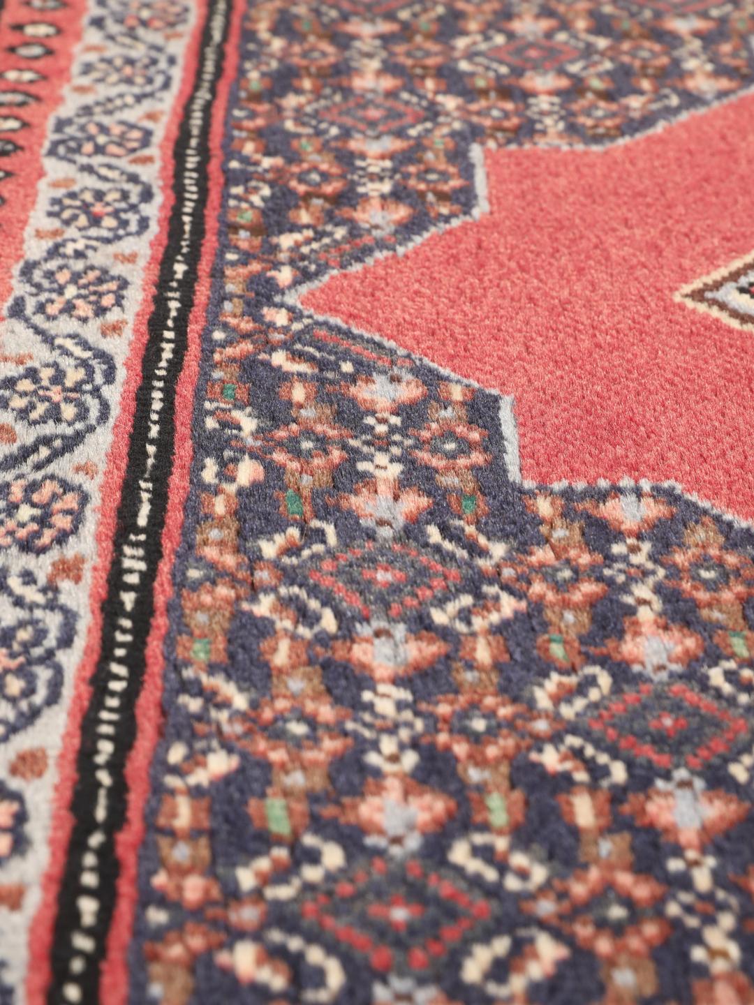 Ein handgeknüpfter Senneh-Teppich aus dem Nahen Osten mit einem roten und blauen geometrischen Design.
