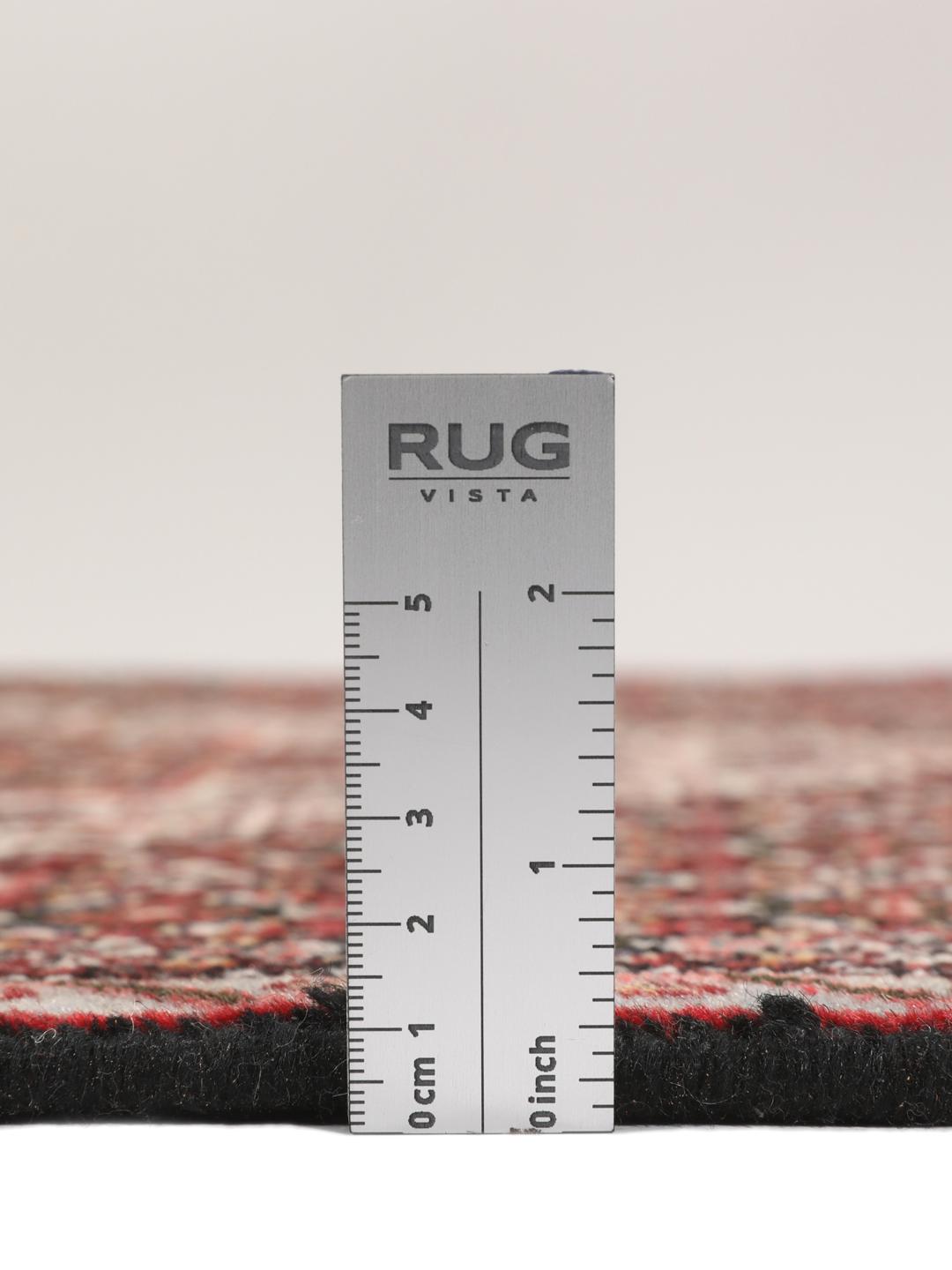 Hand-knotted Senneh rug from the Middle East in dark-red and black tones.