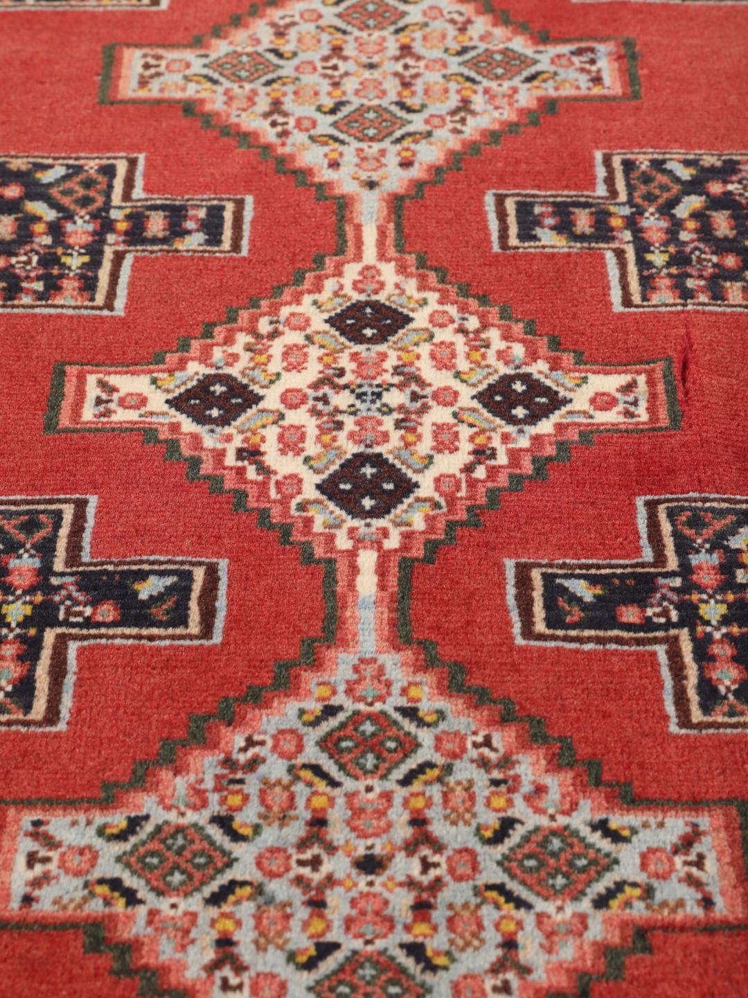 Hand-knotted Senneh rug from the Middle East in red and black