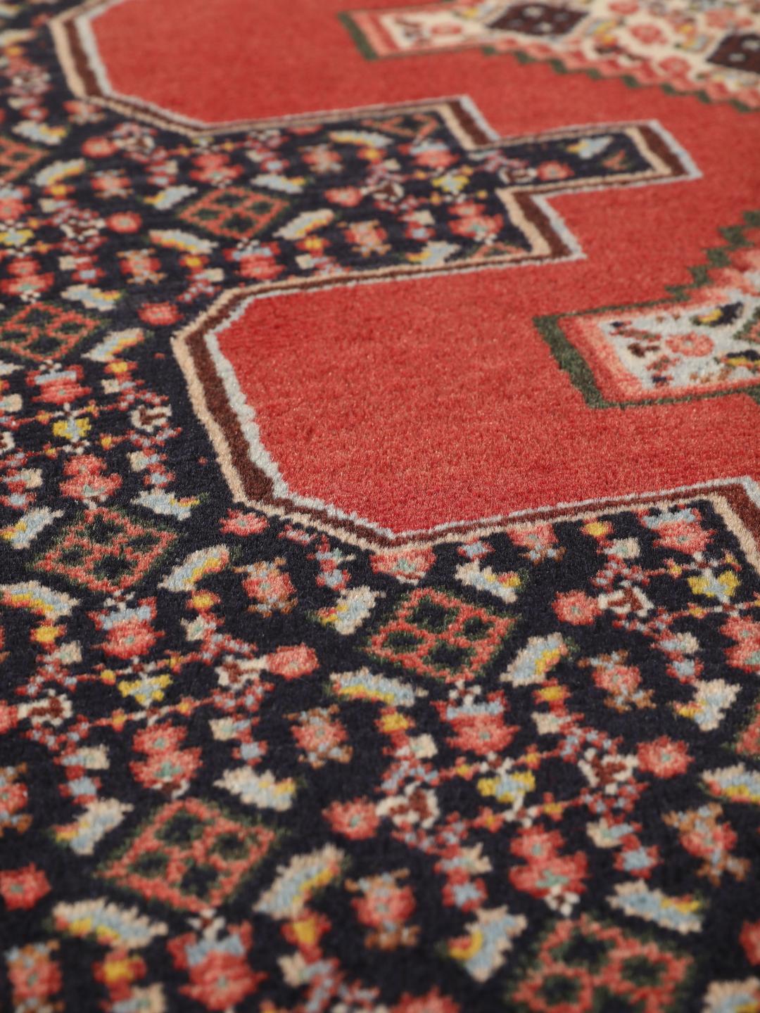 Hand-knotted Senneh rug from the Middle East in red and black