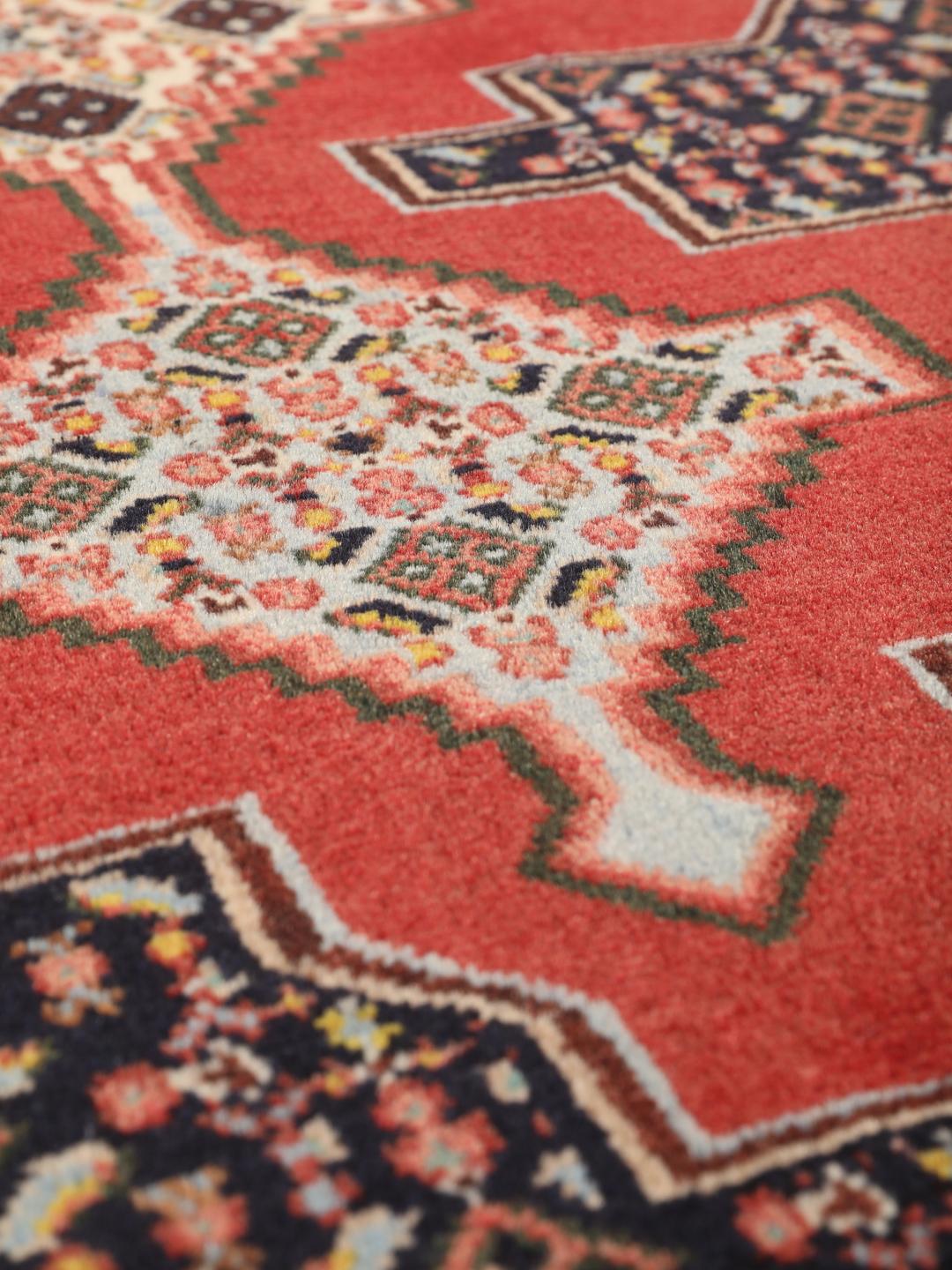 Hand-knotted Senneh rug from the Middle East in red and black