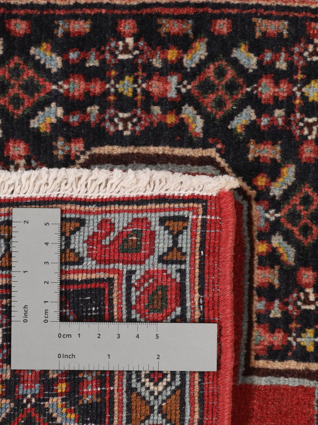Hand-knotted Senneh rug from the Middle East in red and black