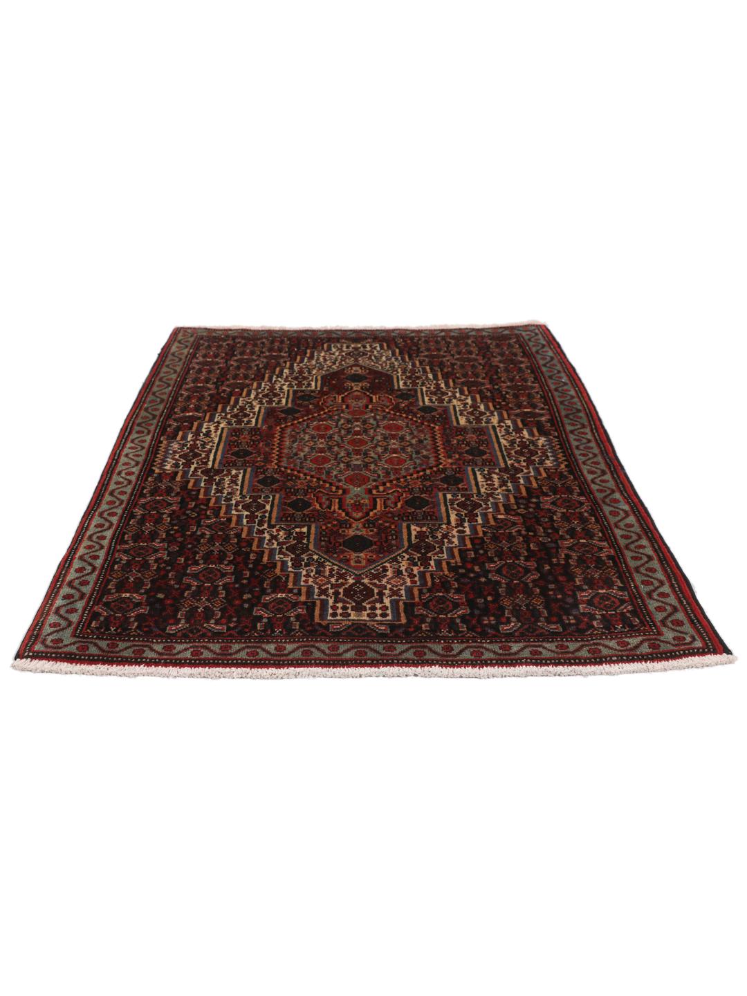A hand-knotted Senneh rug from the Middle East in dark-red and dark-blue tones.
