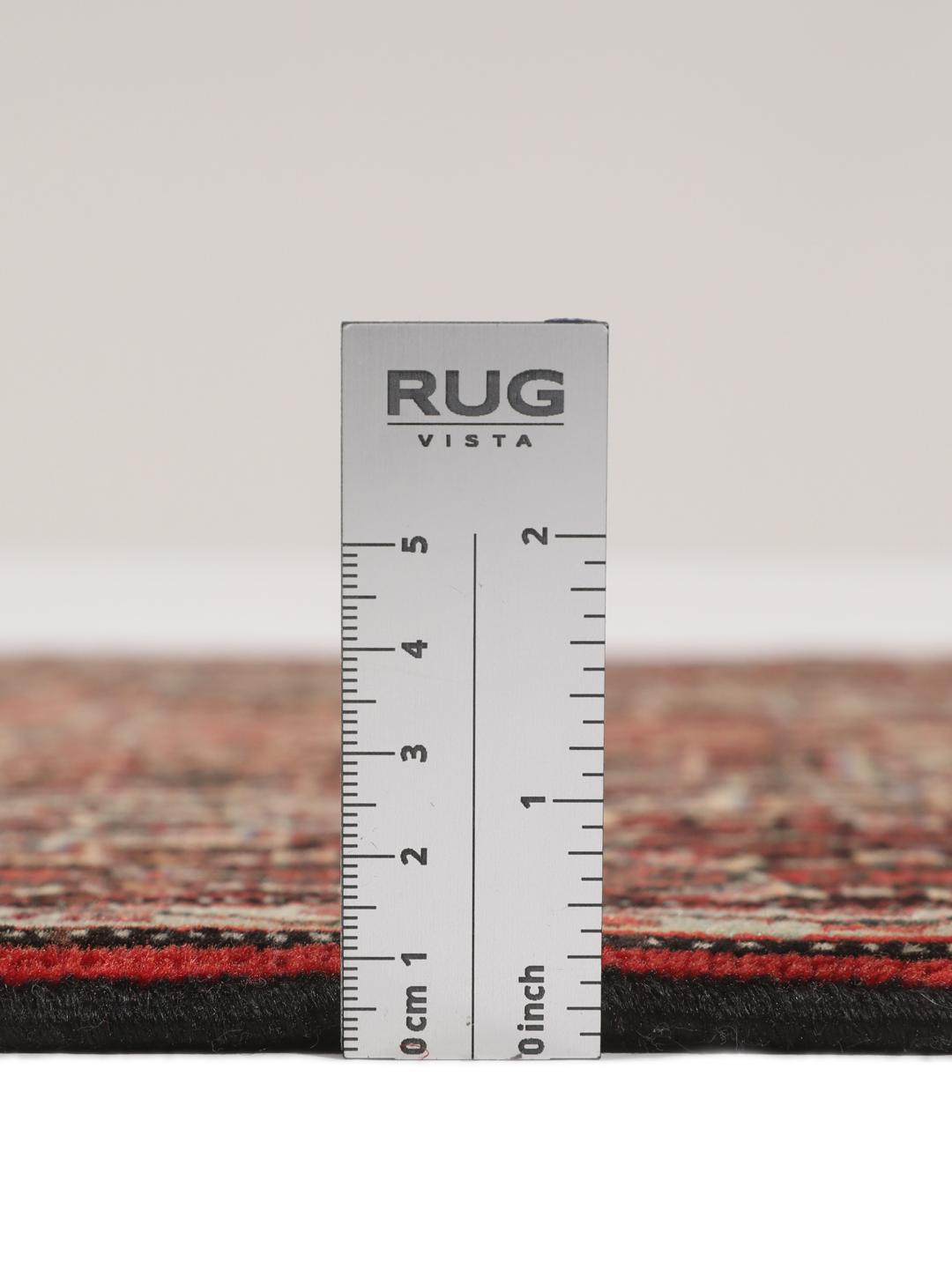 A hand-knotted Senneh rug from the Middle East in dark-red and dark-blue tones.