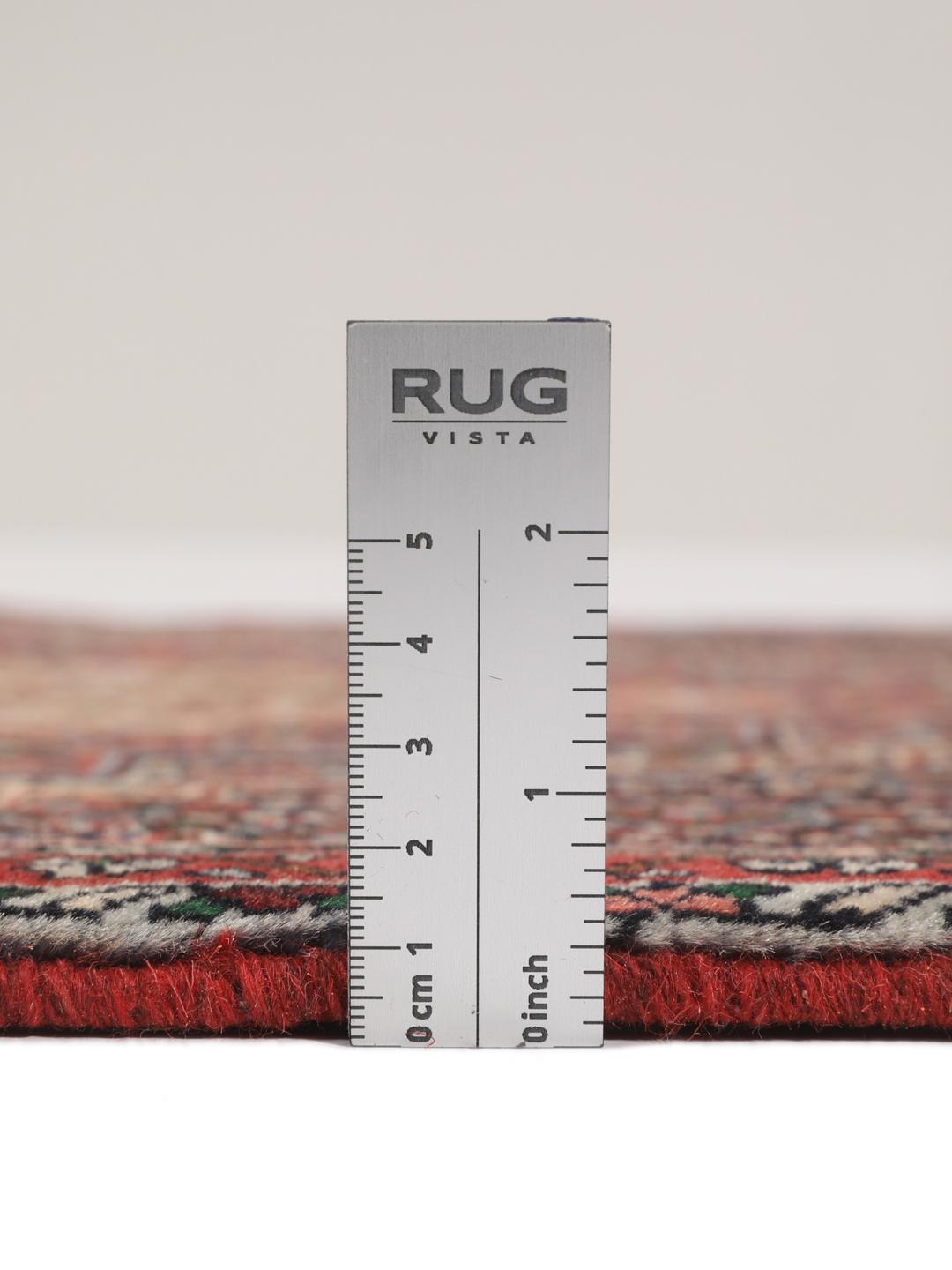Hand-knotted Senneh wool rug in red with intricate geometric medallion patterns