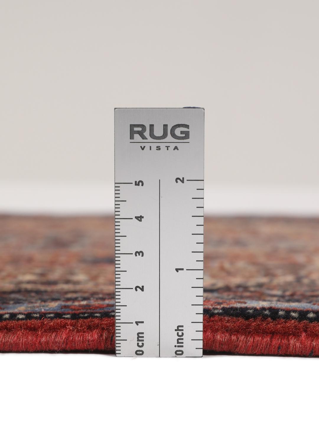 A hand-knotted Senneh rug from the Middle East in dark-blue and dark-red tones.