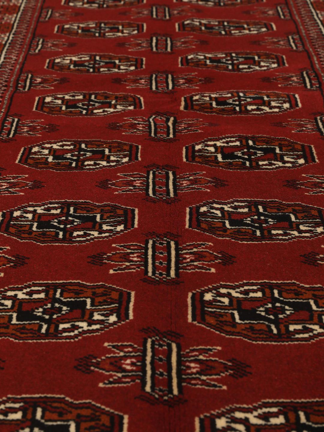 Hand-knotted Middle Eastern Turkaman runner in red with geometric motifs