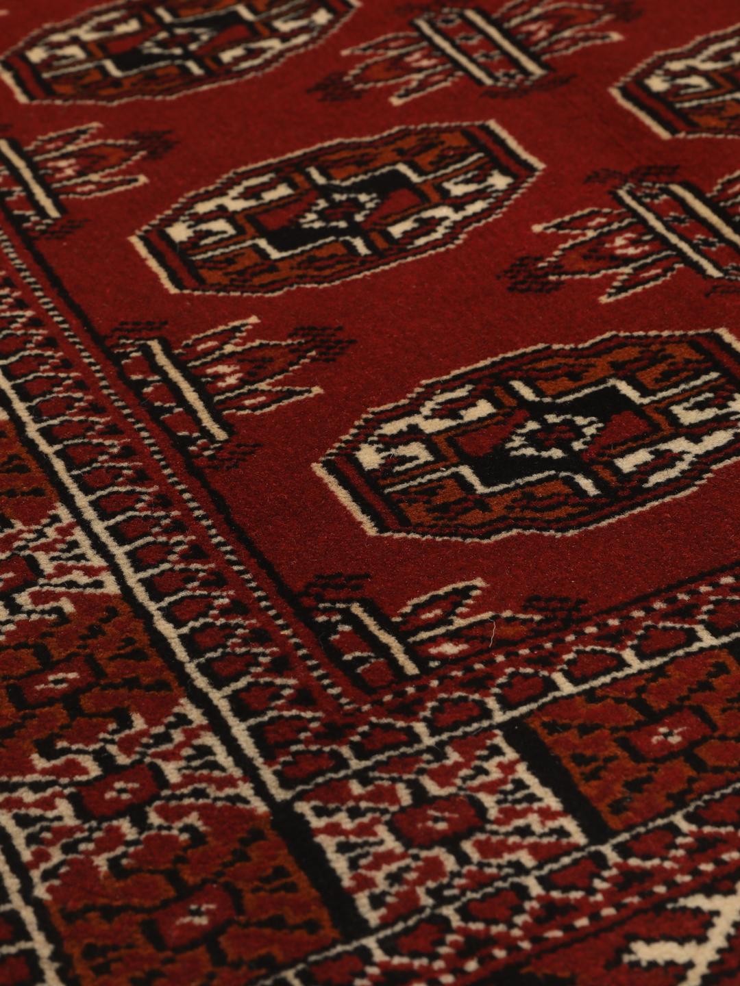 Hand-knotted Middle Eastern Turkaman runner in red with geometric motifs