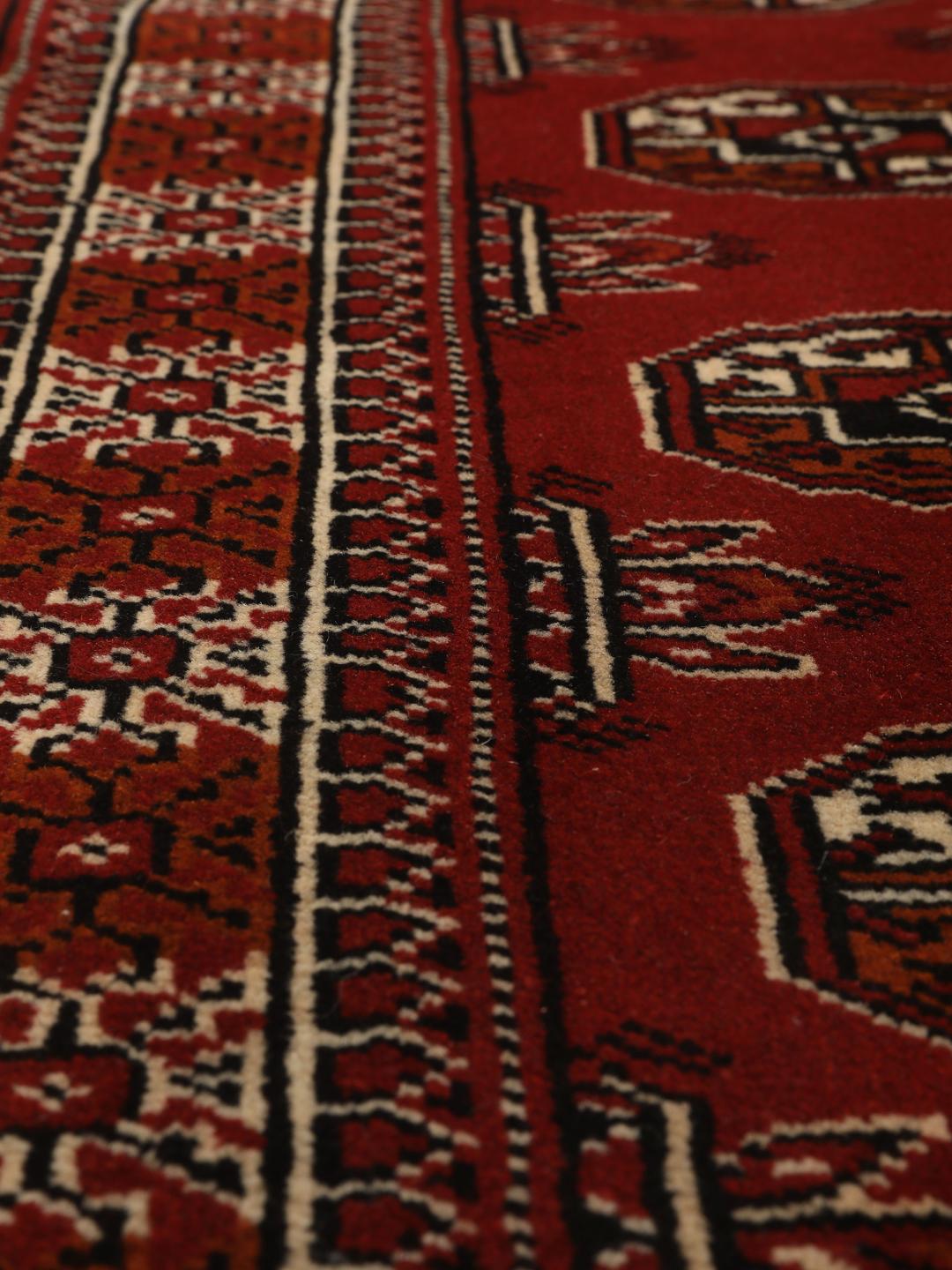 Hand-knotted Middle Eastern Turkaman runner in red with geometric motifs
