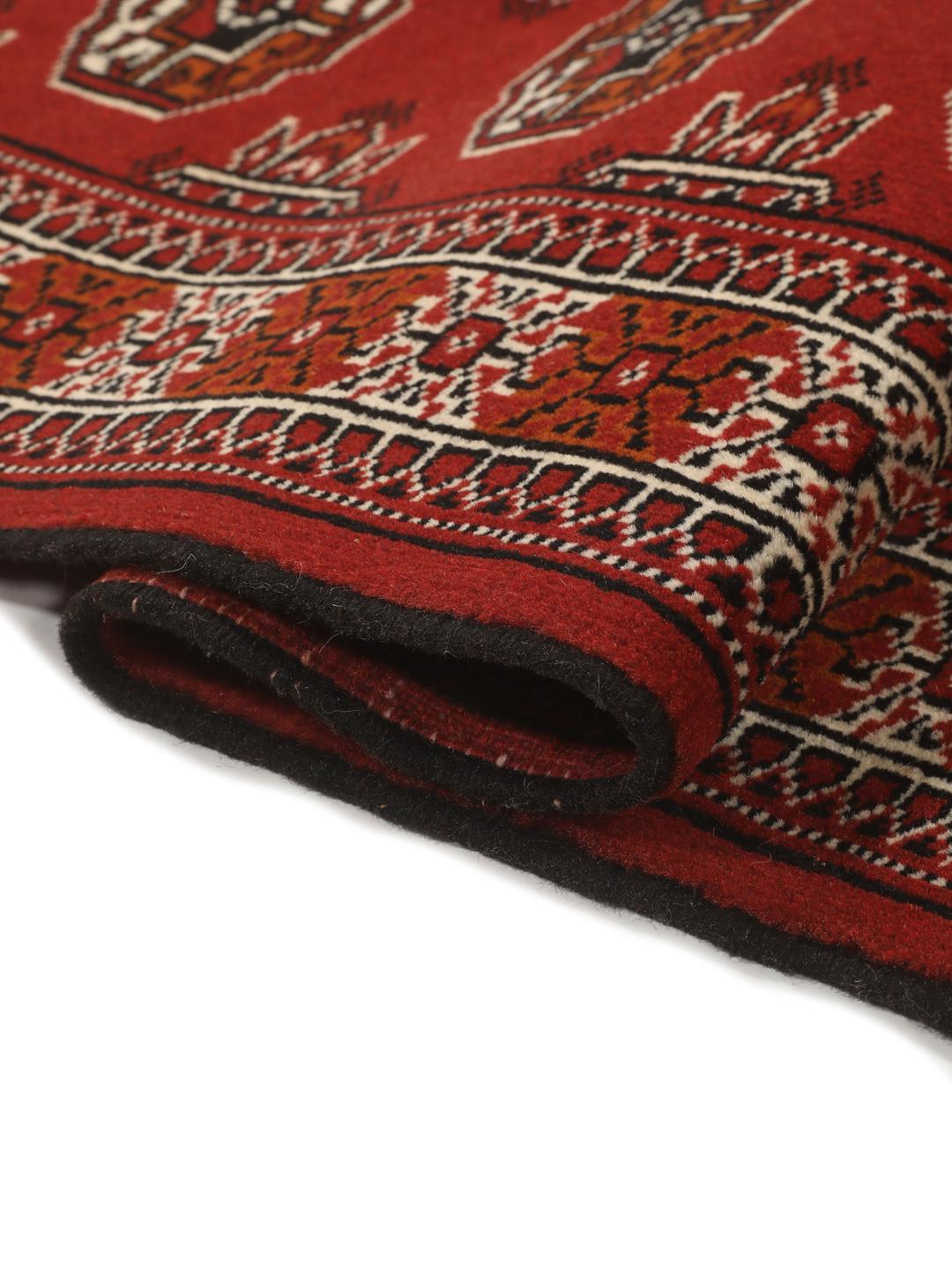 Hand-knotted Middle Eastern Turkaman runner in red with geometric motifs