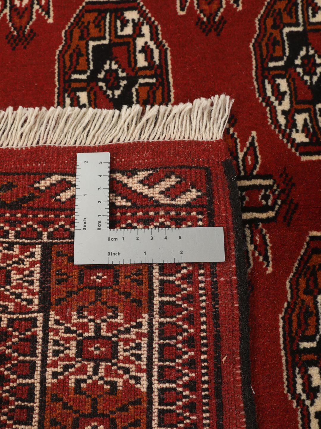 Hand-knotted Middle Eastern Turkaman runner in red with geometric motifs