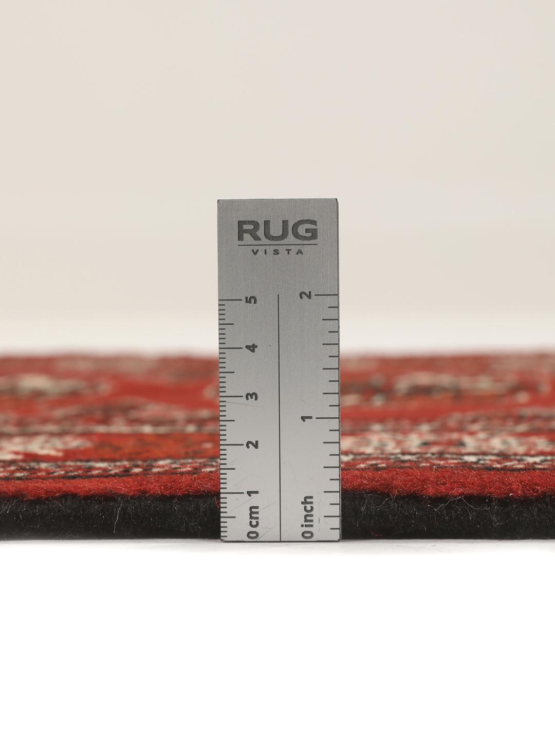 A hand-knotted Middle Eastern Turkaman runner in deep red with geometric medallion patterns.