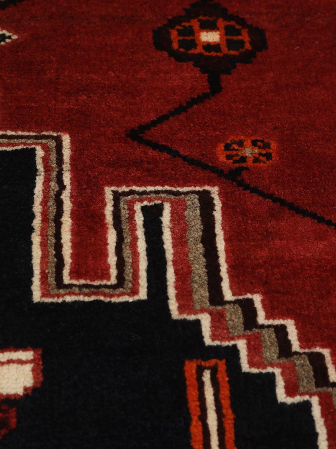 Hand-knotted Shiraz rug from the Middle East featuring a red and black geometric design