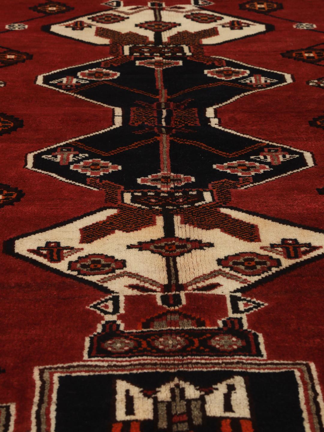 Hand-knotted Shiraz rug from the Middle East featuring a red and black geometric design