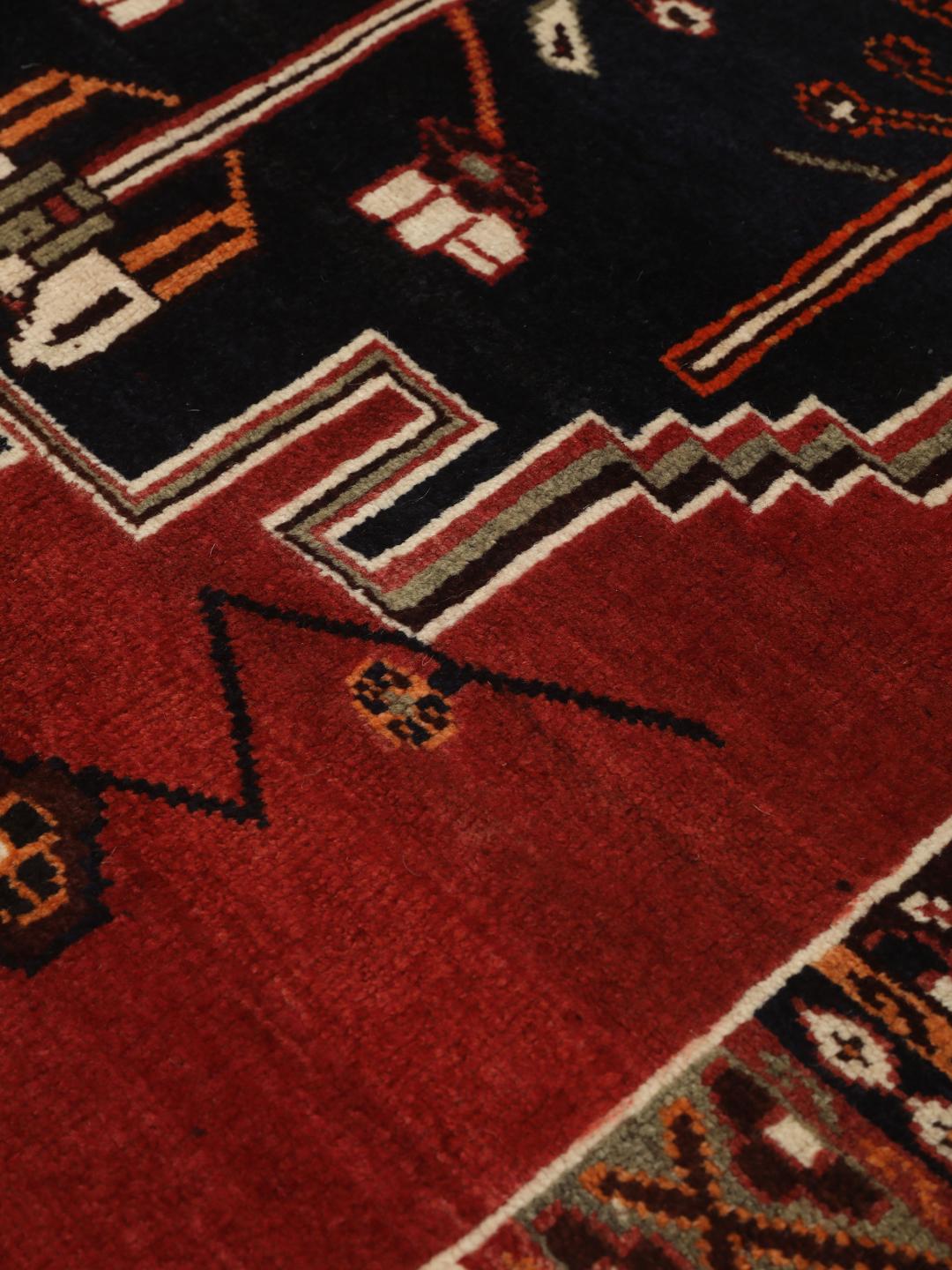Hand-knotted Shiraz rug from the Middle East featuring a red and black geometric design