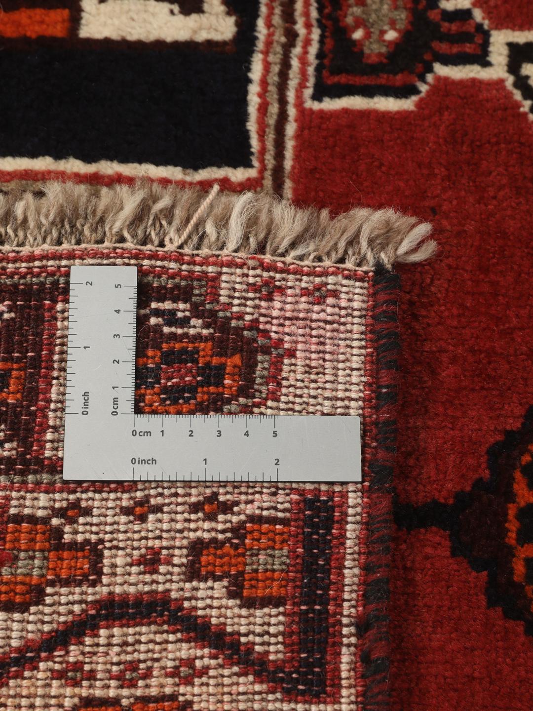 Hand-knotted Shiraz rug from the Middle East featuring a red and black geometric design