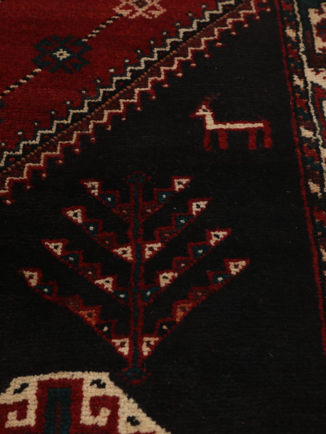 Hand-knotted Shiraz rug from the Middle East featuring a vibrant multicolor tribal design.