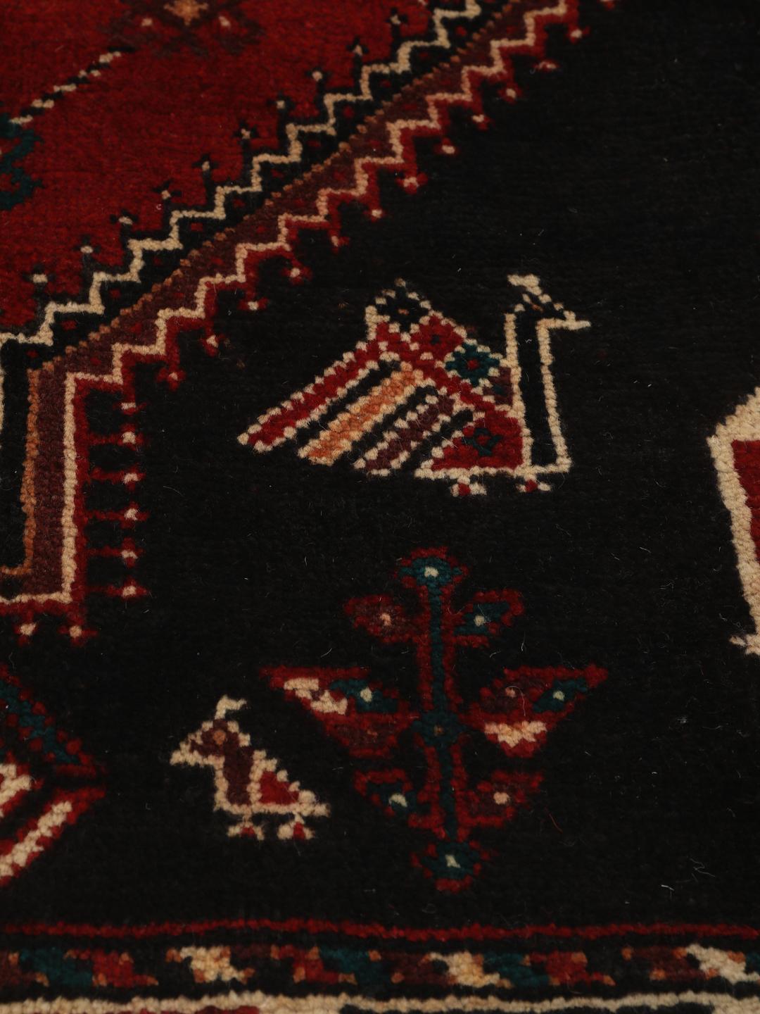 Hand-knotted Shiraz rug from the Middle East featuring a vibrant multicolor tribal design.