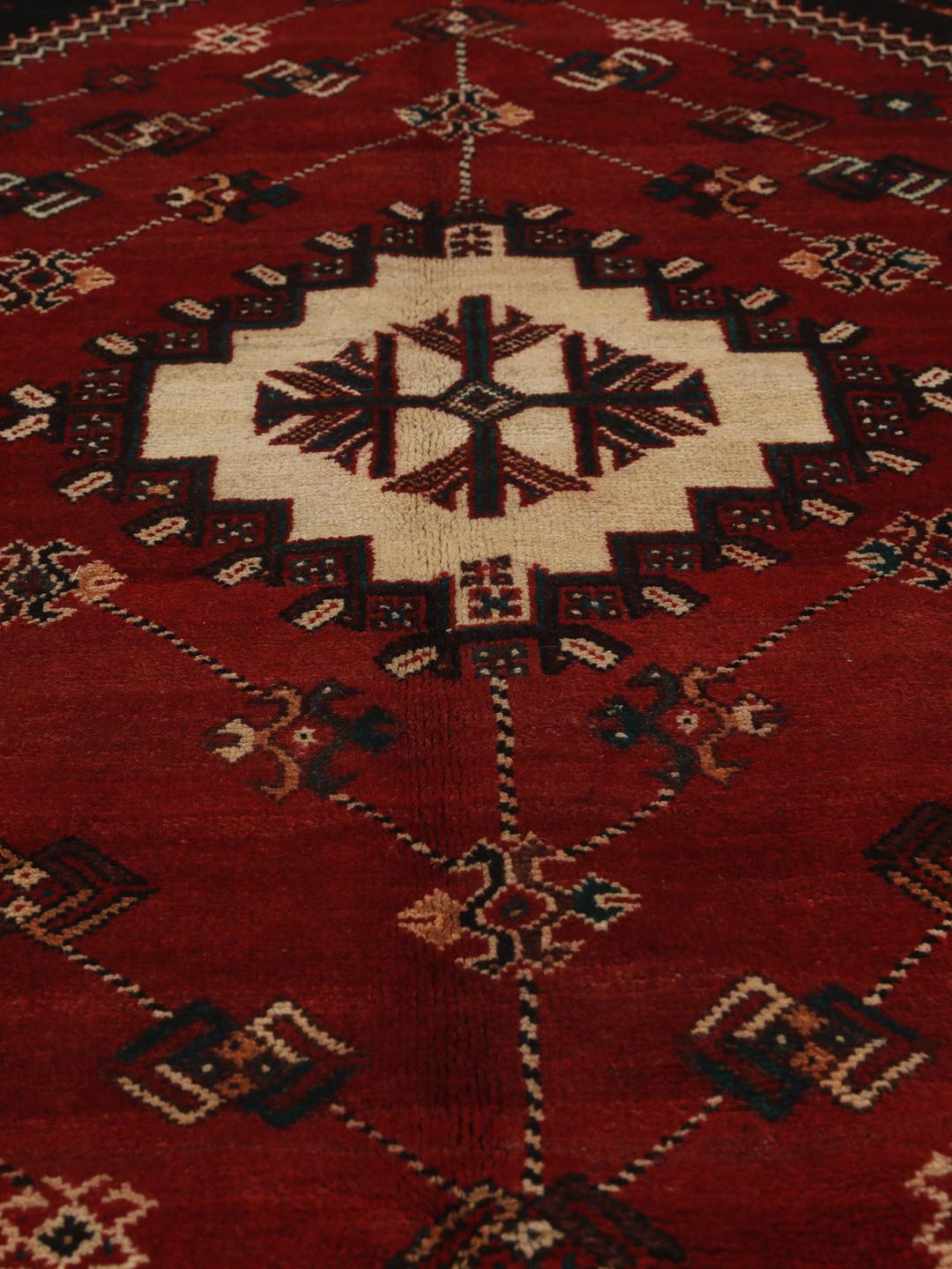 Hand-knotted Shiraz rug from the Middle East featuring a vibrant multicolor tribal design.