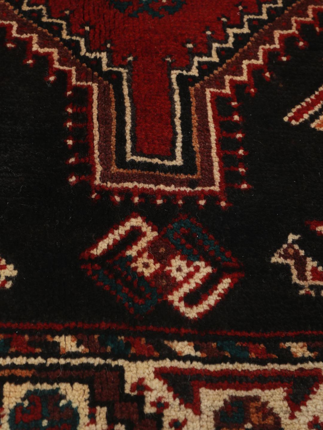 Hand-knotted Shiraz rug from the Middle East featuring a vibrant multicolor tribal design.
