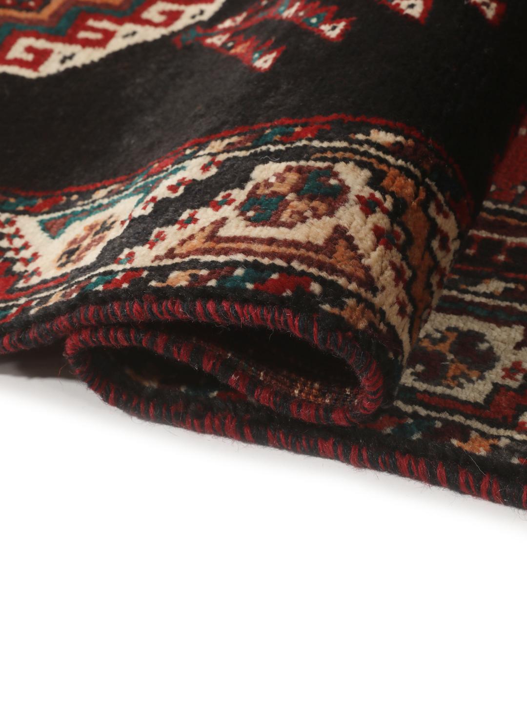 Hand-knotted Shiraz rug from the Middle East featuring a vibrant multicolor tribal design.