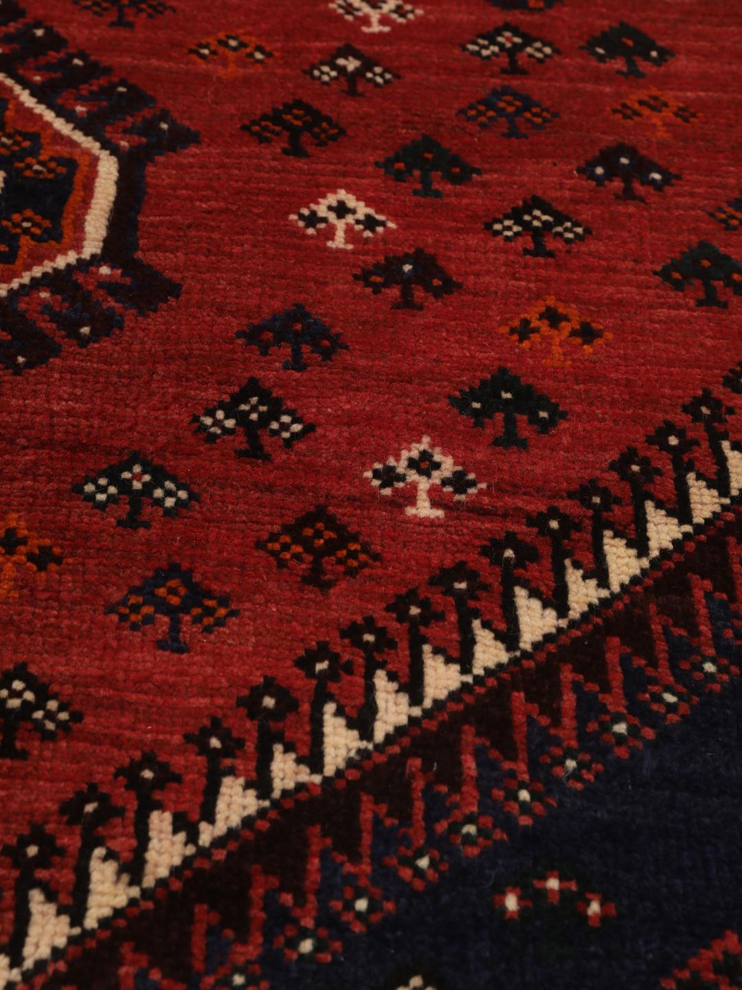 Hand-knotted Shiraz rug from the Middle East in red and navy blue