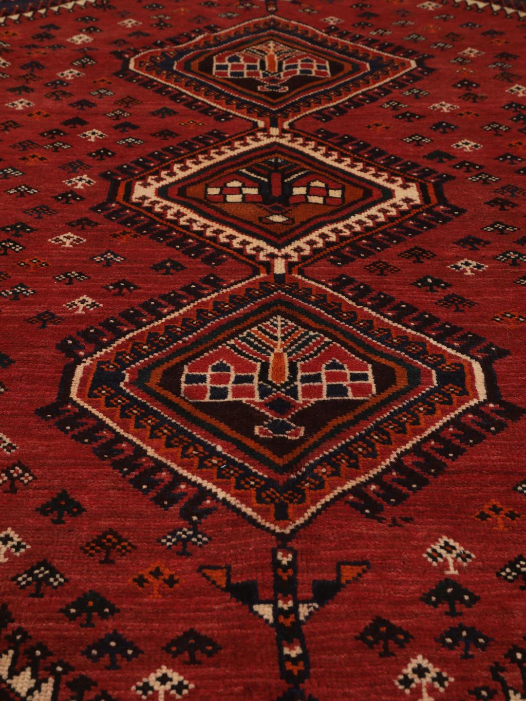 Hand-knotted Shiraz rug from the Middle East in red and navy blue