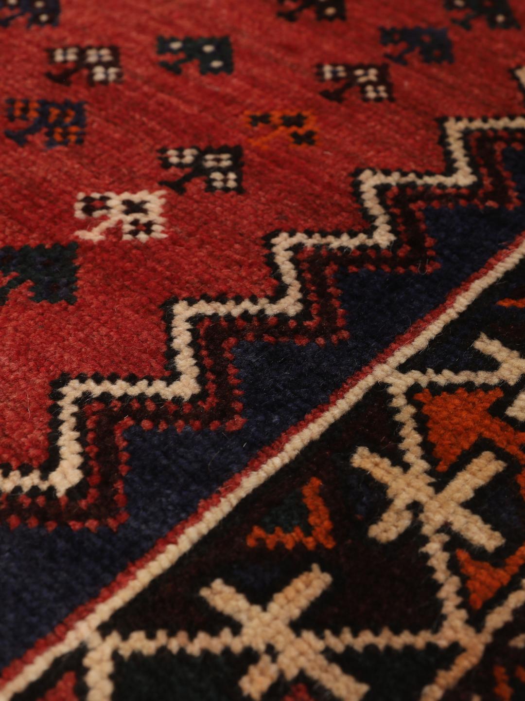 Hand-knotted Shiraz rug from the Middle East in red and navy blue