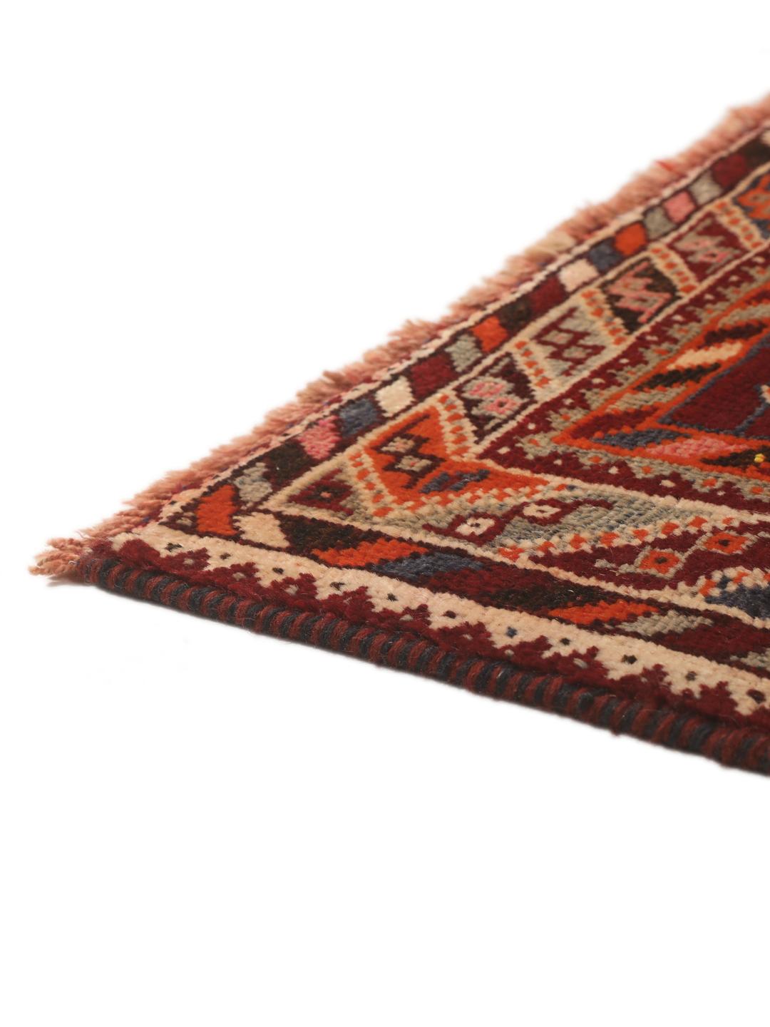 Hand-knotted Qashqai rug from the Middle East featuring geometric patterns in dark red and multicolour wool.