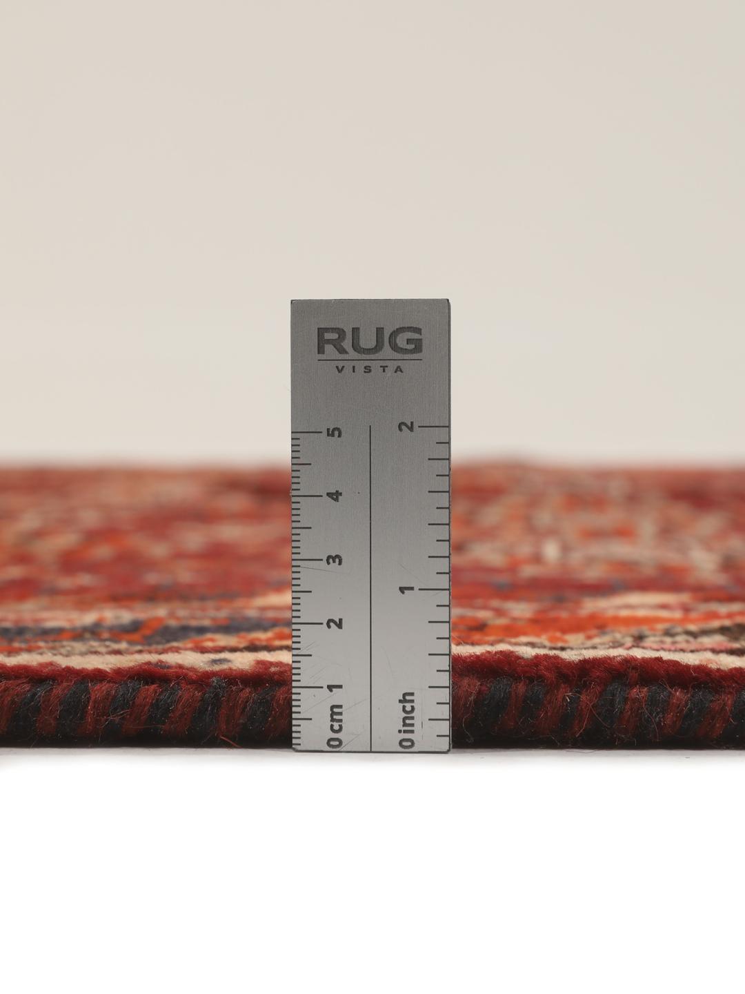 Hand-knotted Qashqai rug from the Middle East featuring geometric patterns in dark red and multicolour wool.