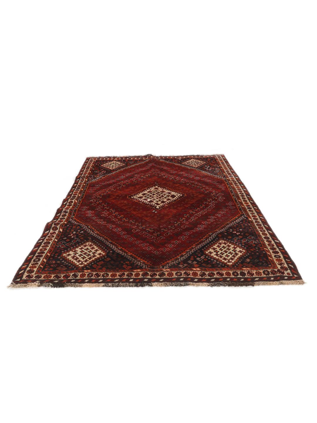 Hand-knotted Qashqai rug from the Middle East with a red field and geometric patterns