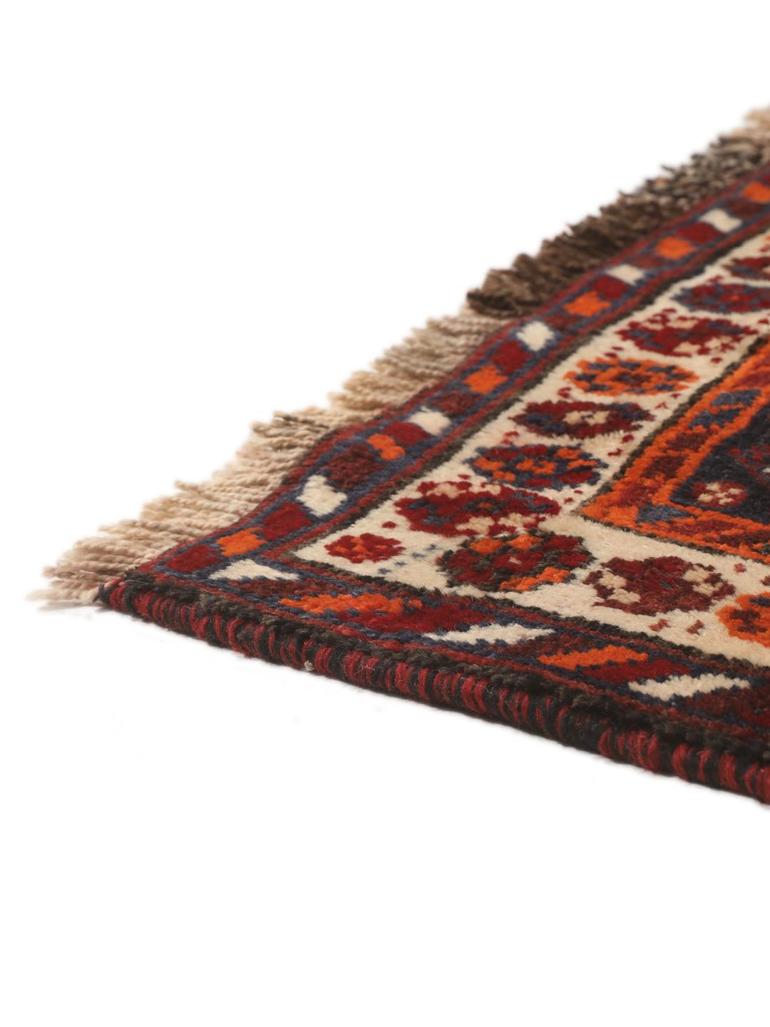 Hand-knotted Qashqai rug from the Middle East with a red field and geometric patterns