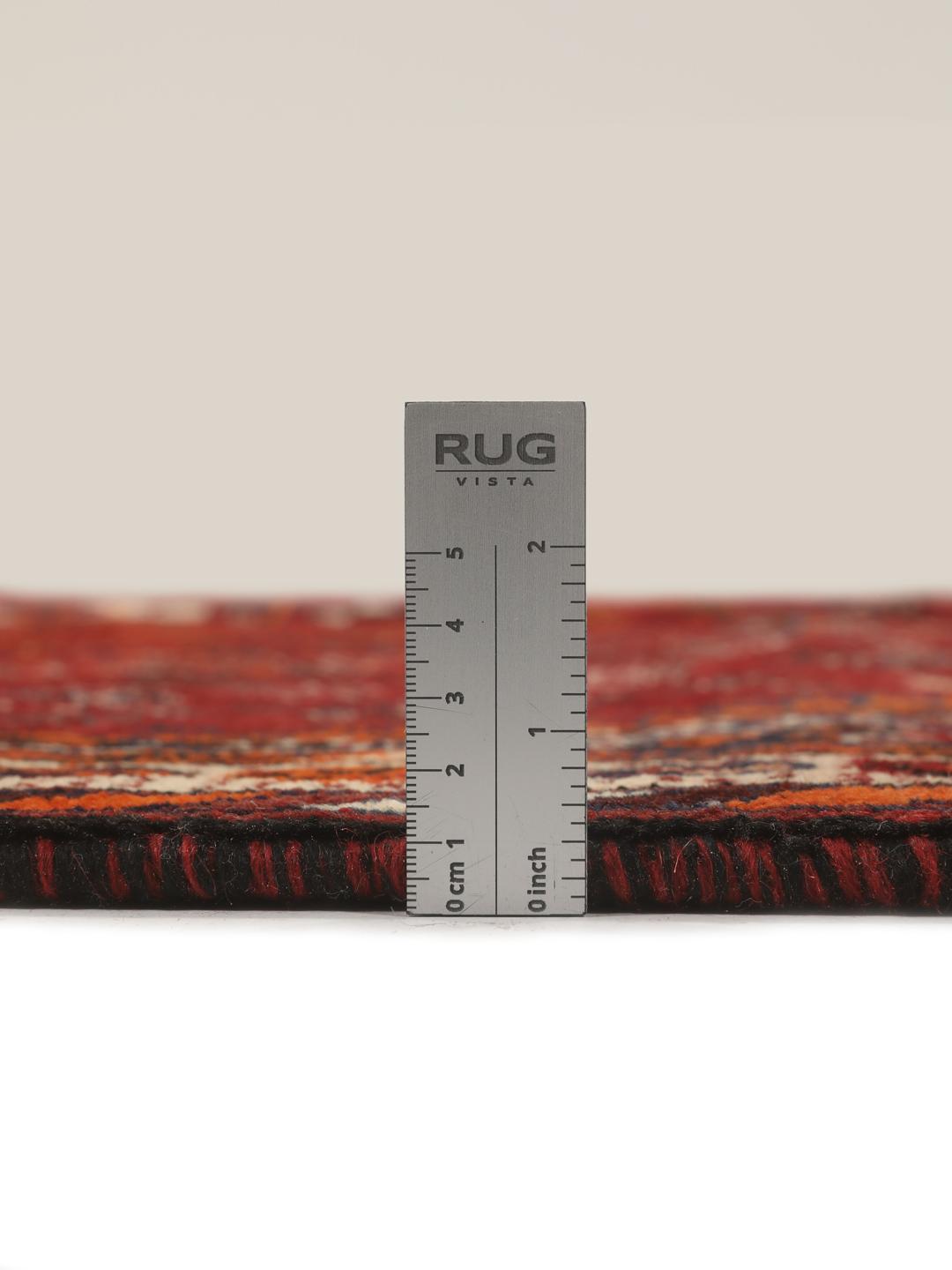 Hand-knotted Qashqai rug from the Middle East with a red field and geometric patterns