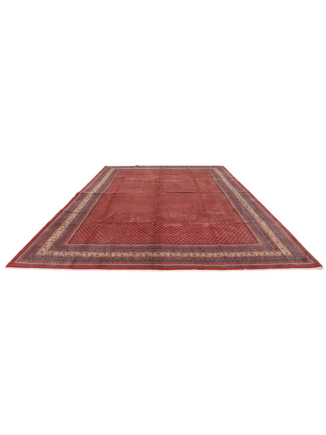 A large hand-knotted Sarough Mir rug with a deep red field and intricate border from the Middle East.
