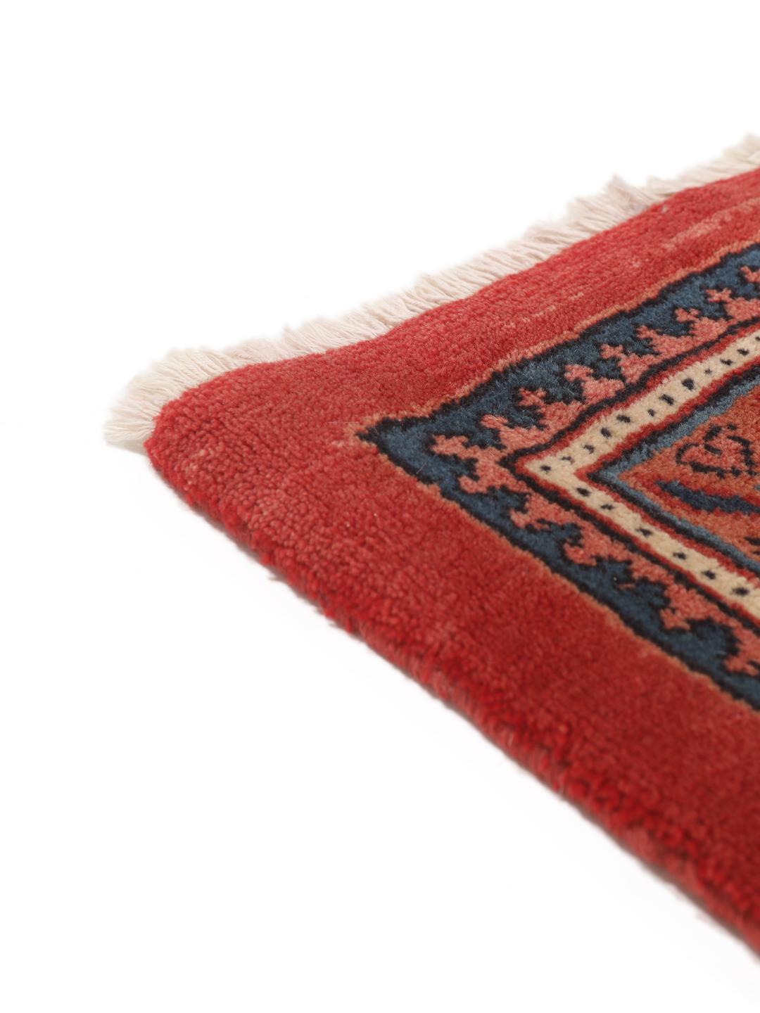 A large hand-knotted Sarough Mir rug with a deep red field and intricate border from the Middle East.