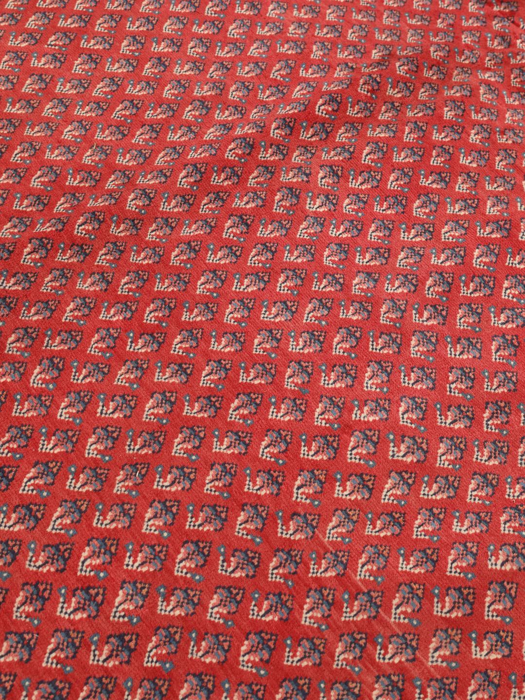 A large hand-knotted Sarough Mir rug with a deep red field and intricate border from the Middle East.