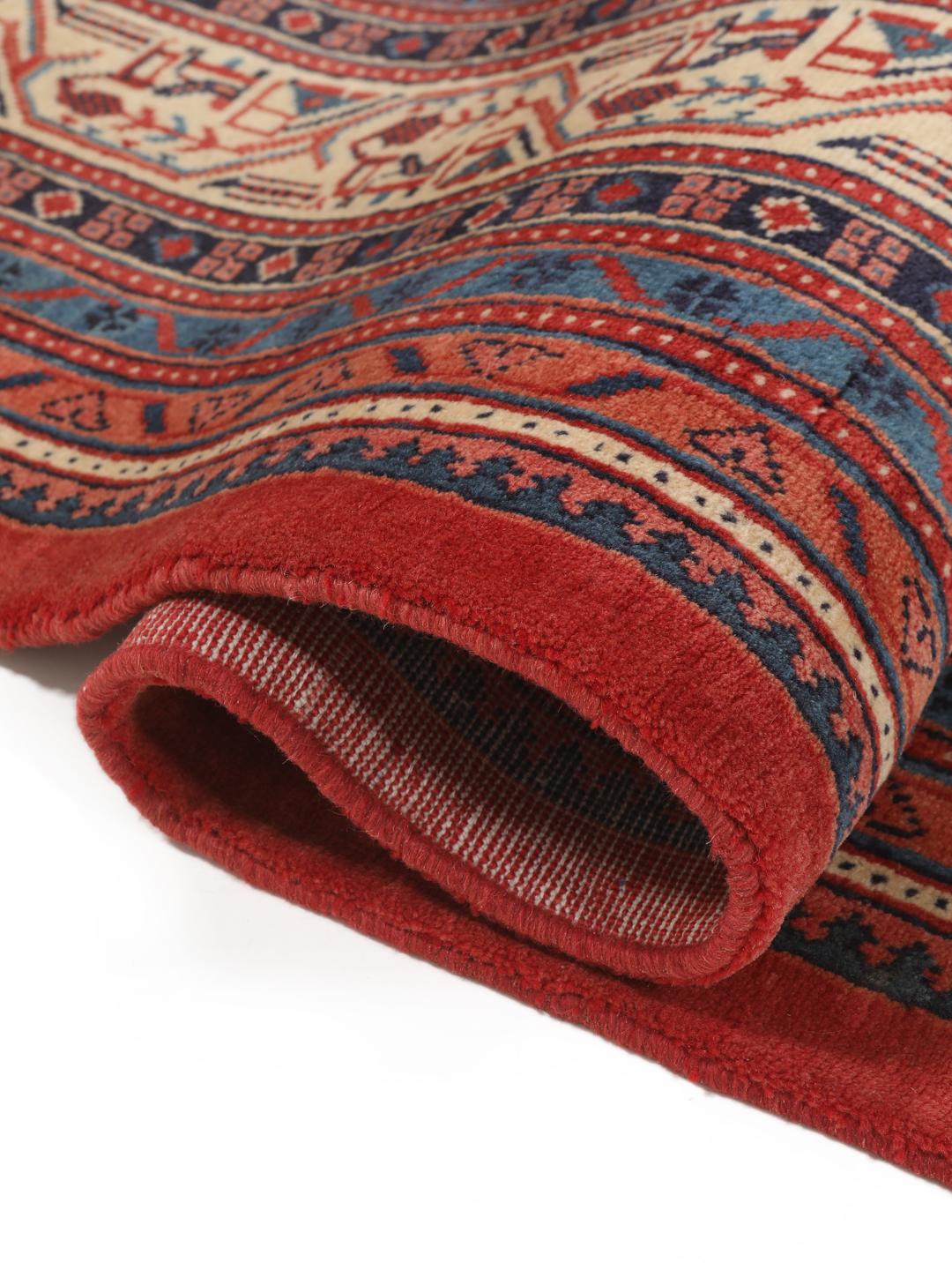 A large hand-knotted Sarough Mir rug with a deep red field and intricate border from the Middle East.
