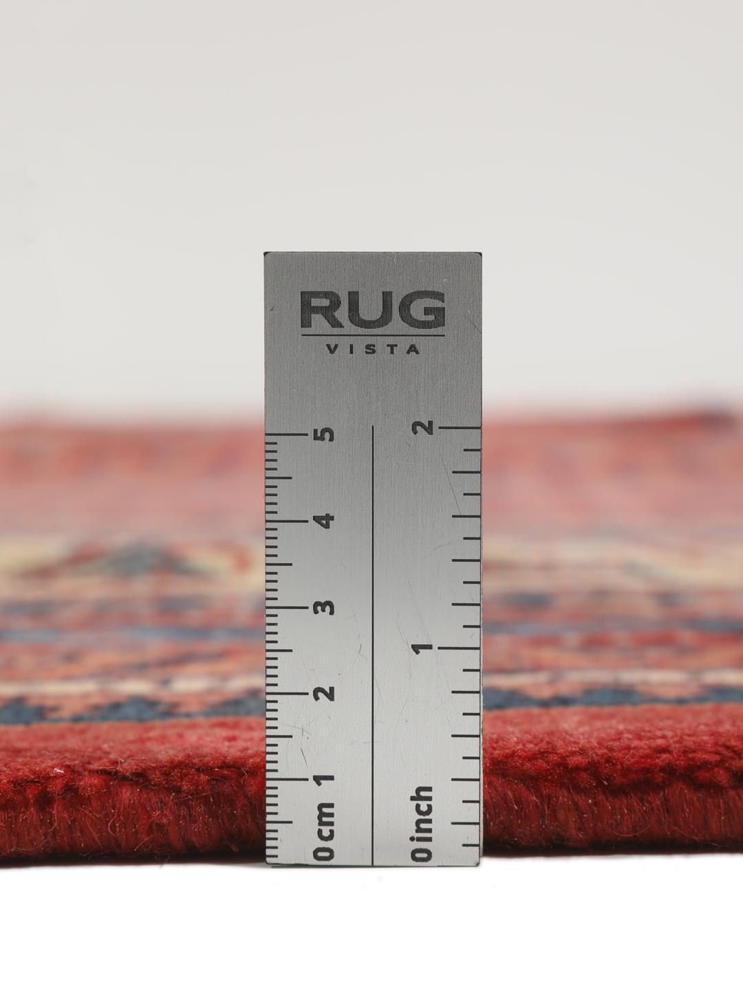 A large hand-knotted Sarough Mir rug with a deep red field and intricate border from the Middle East.