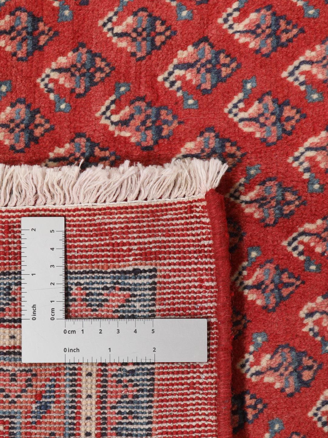 A large hand-knotted Sarough Mir rug with a deep red field and intricate border from the Middle East.