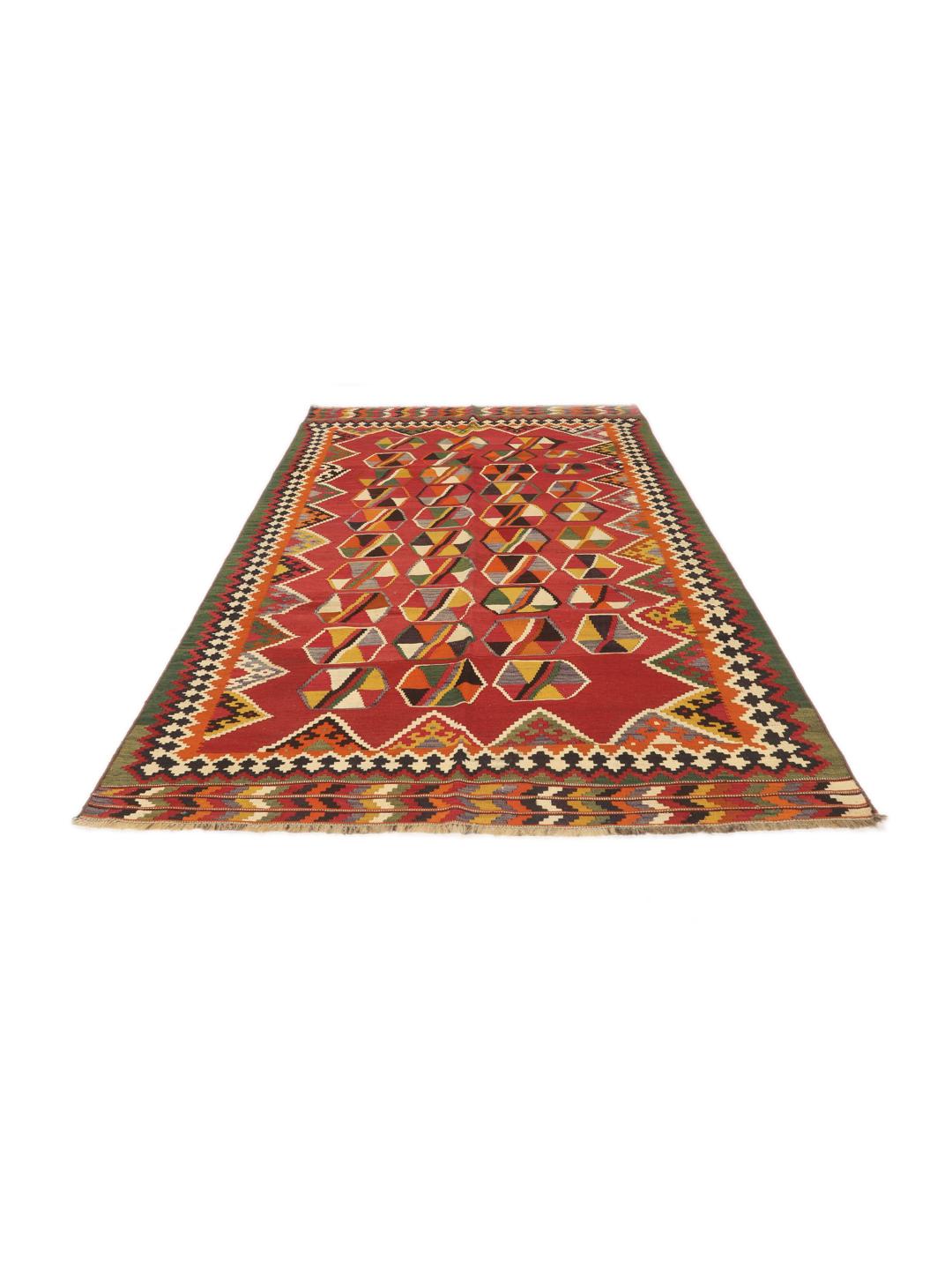 Et håndvævet vintage-kelimtæppe fra Mellemøsten med en rød flade og geometriske motiver.
