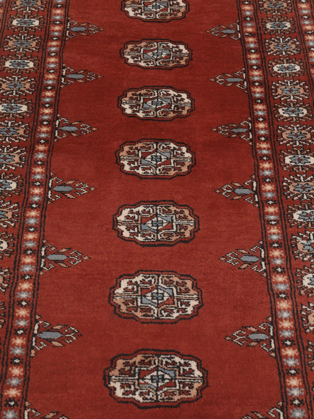 Hand-knotted Pakistan Bokhara runner in deep red