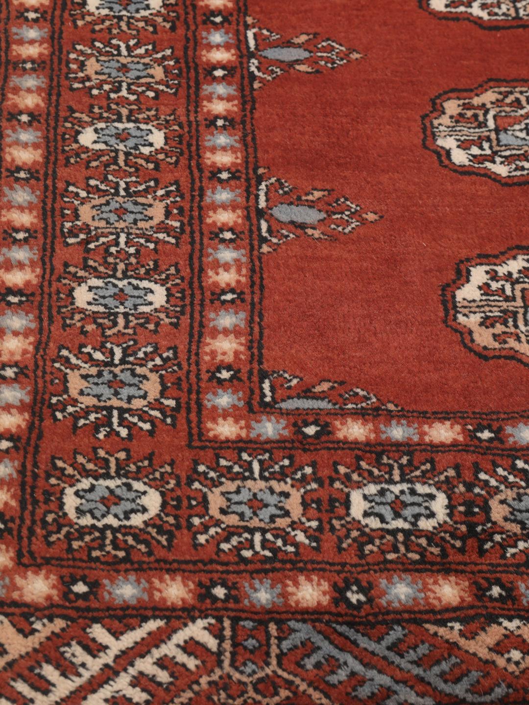 Hand-knotted Pakistan Bokhara runner in deep red