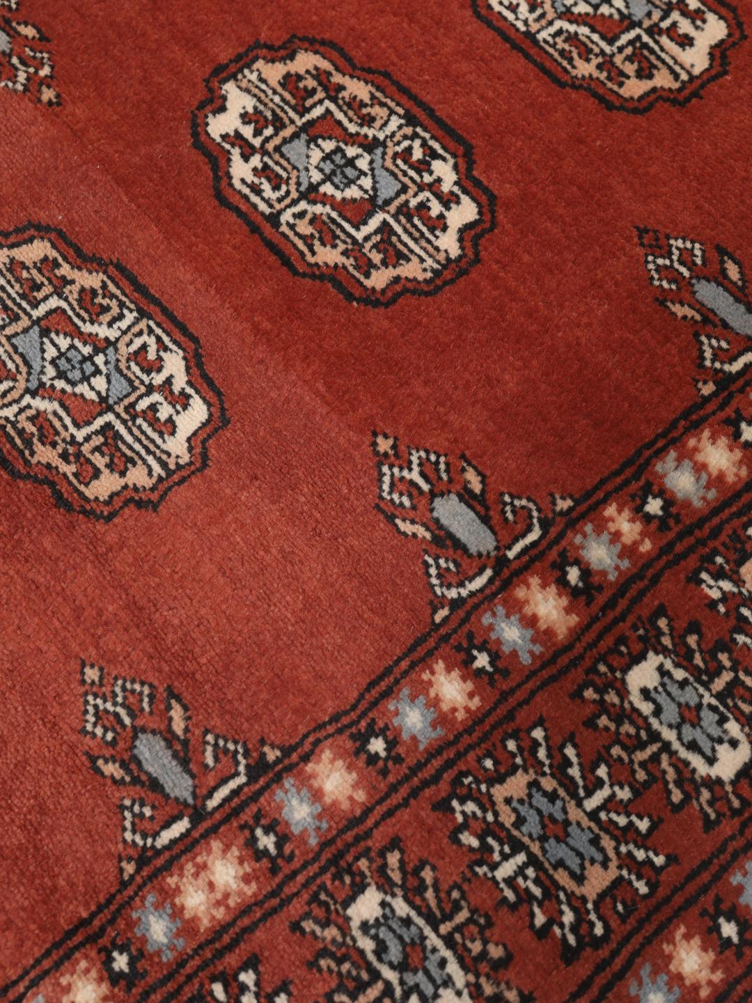 Hand-knotted Pakistan Bokhara runner in deep red