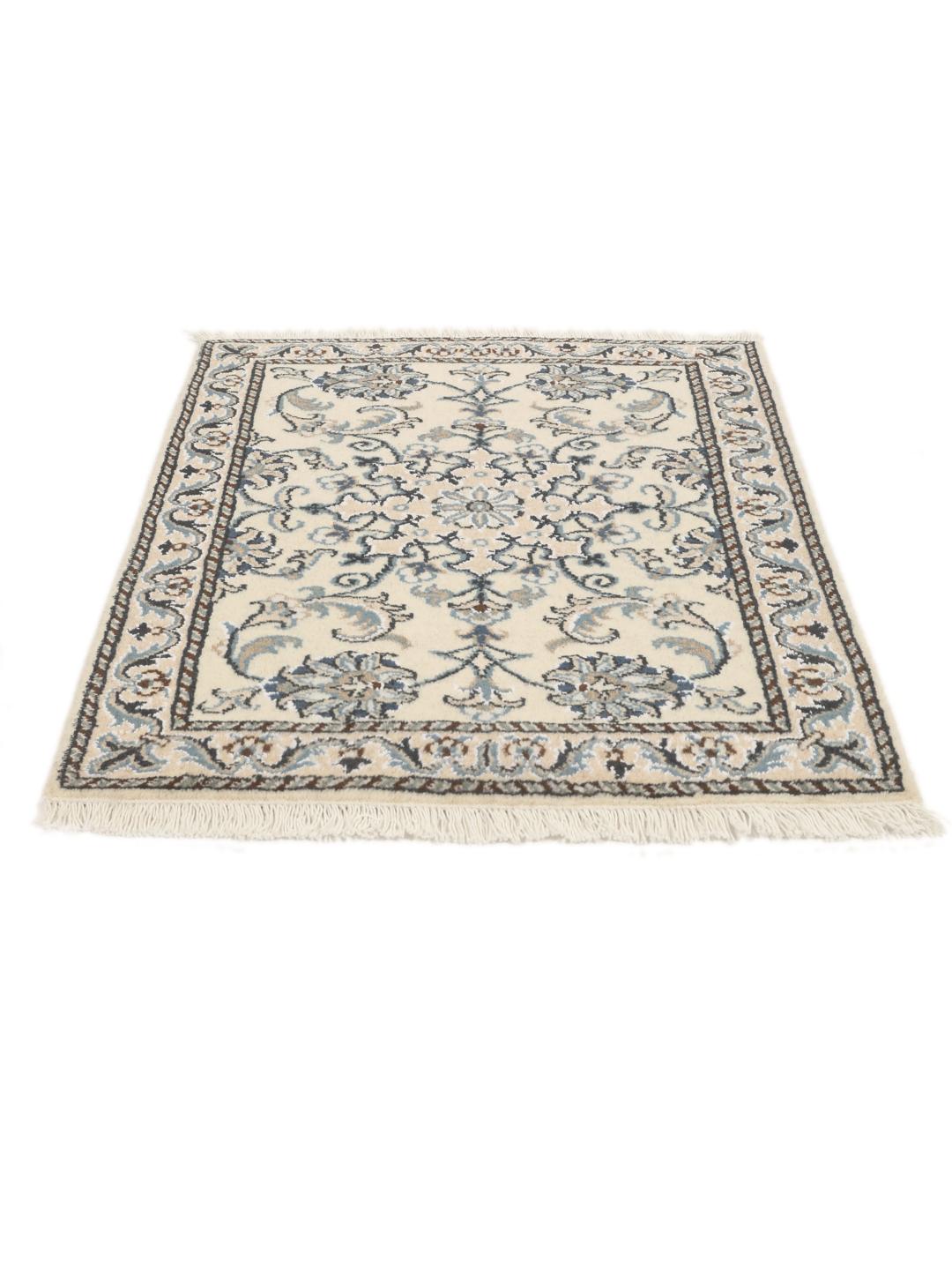 Hand-knotted Nain rug from the Middle East with a light beige field and blue floral motifs