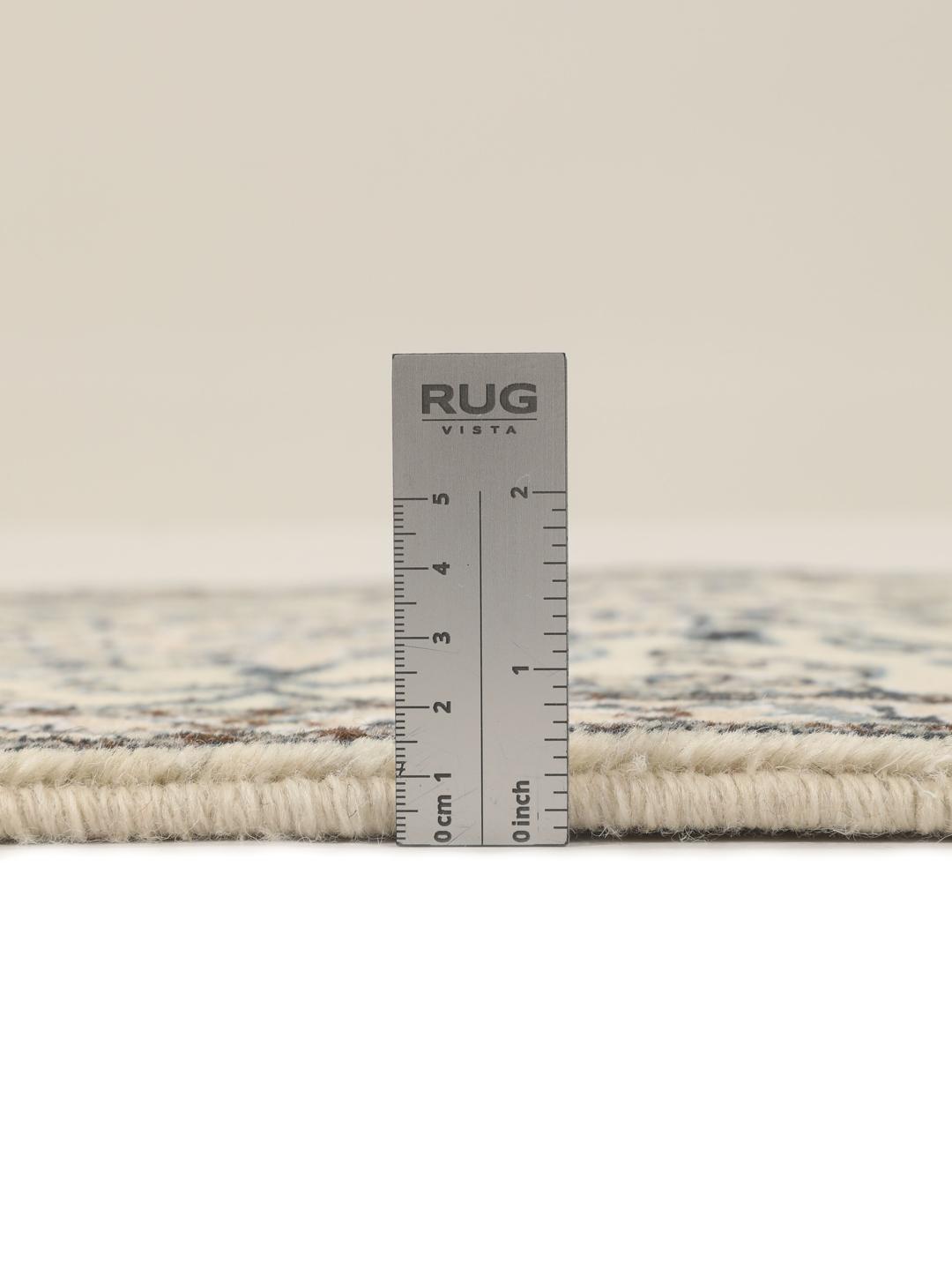Hand-knotted Nain rug from the Middle East with a light beige field and blue floral motifs